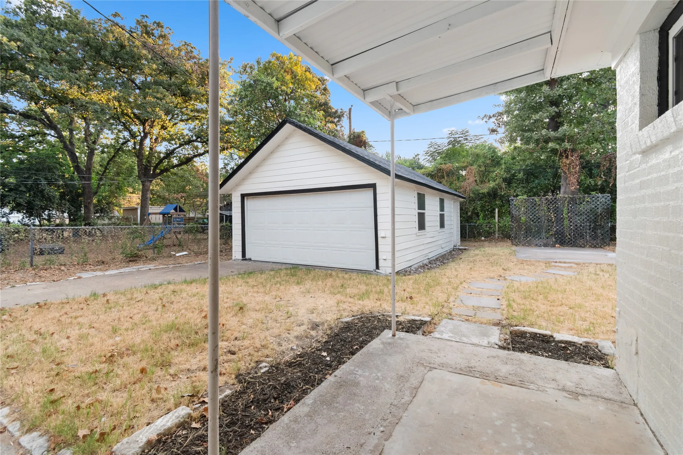 Backyard with two car garage, driveway.