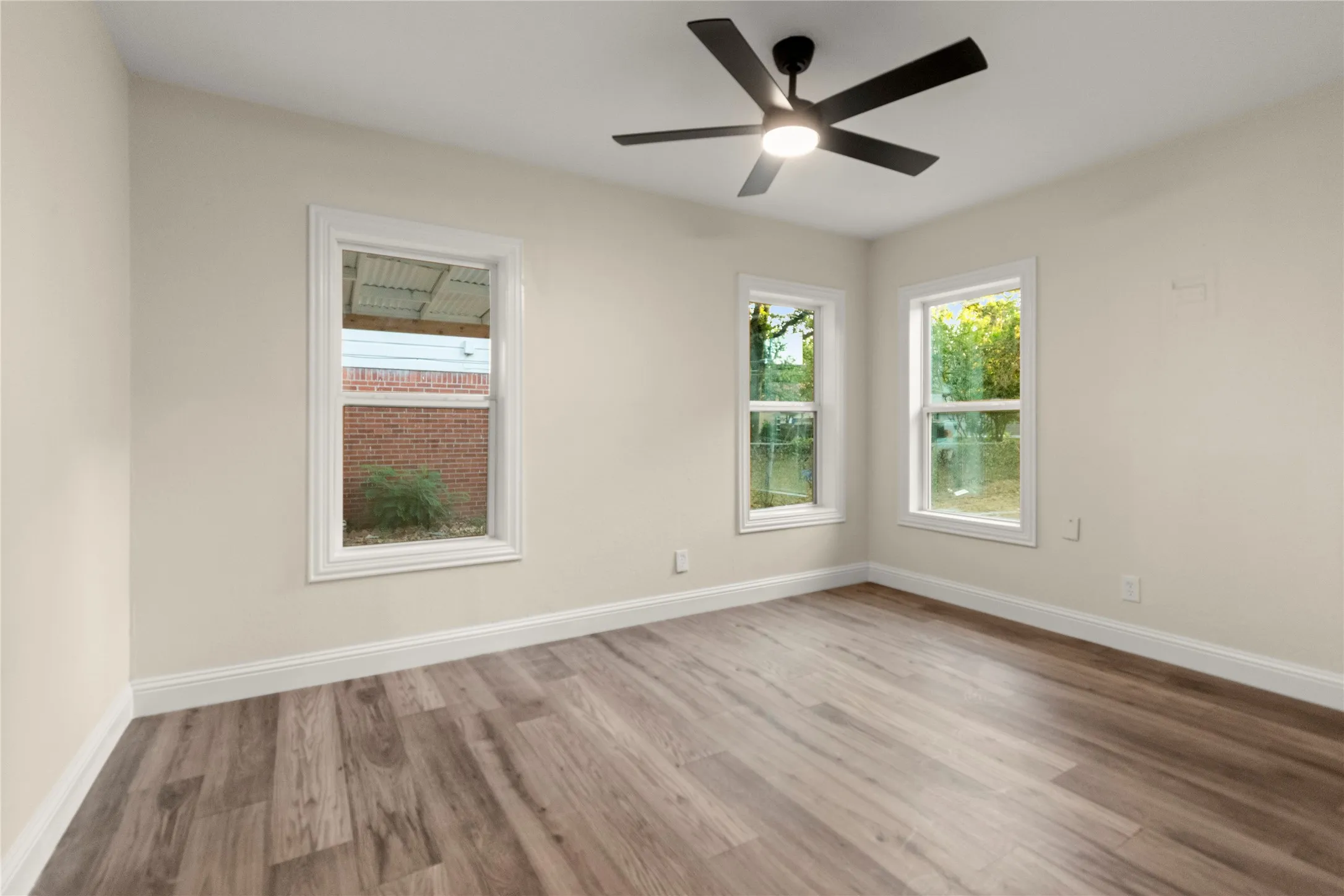 Bedroom#2 with modern ceiling fan illuminate wood-finish flooring, two closets