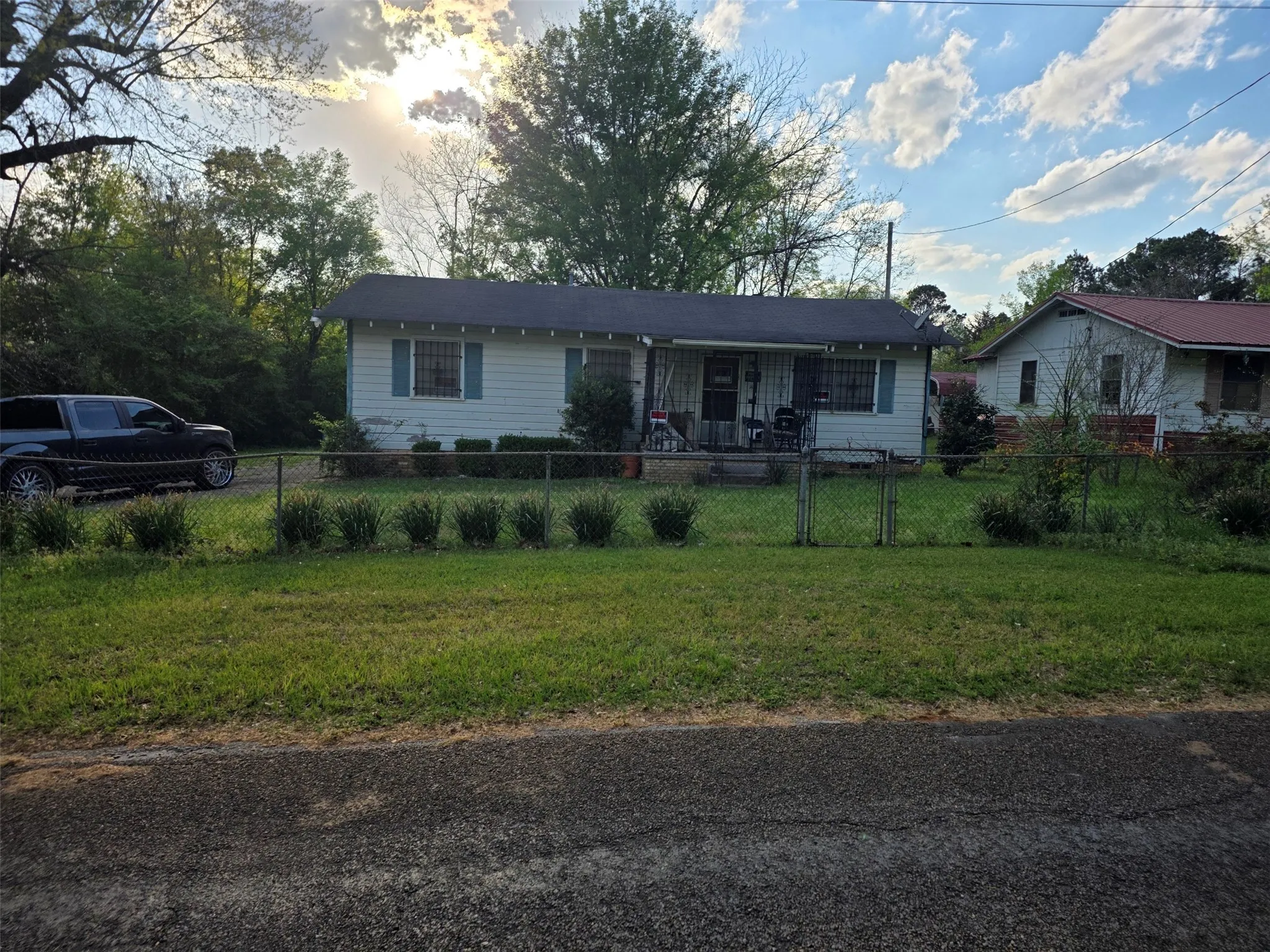 Single-story residence with a covered front porch and a fenced front yard