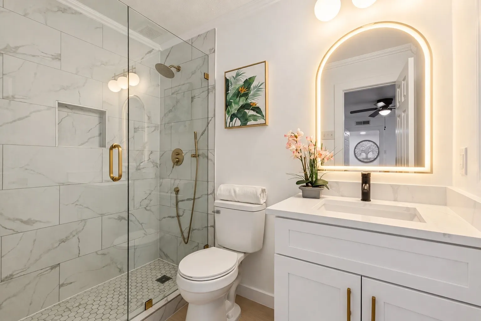 Enclosed glass shower with a rain shower head, built-in niche, and hex-tile flooring