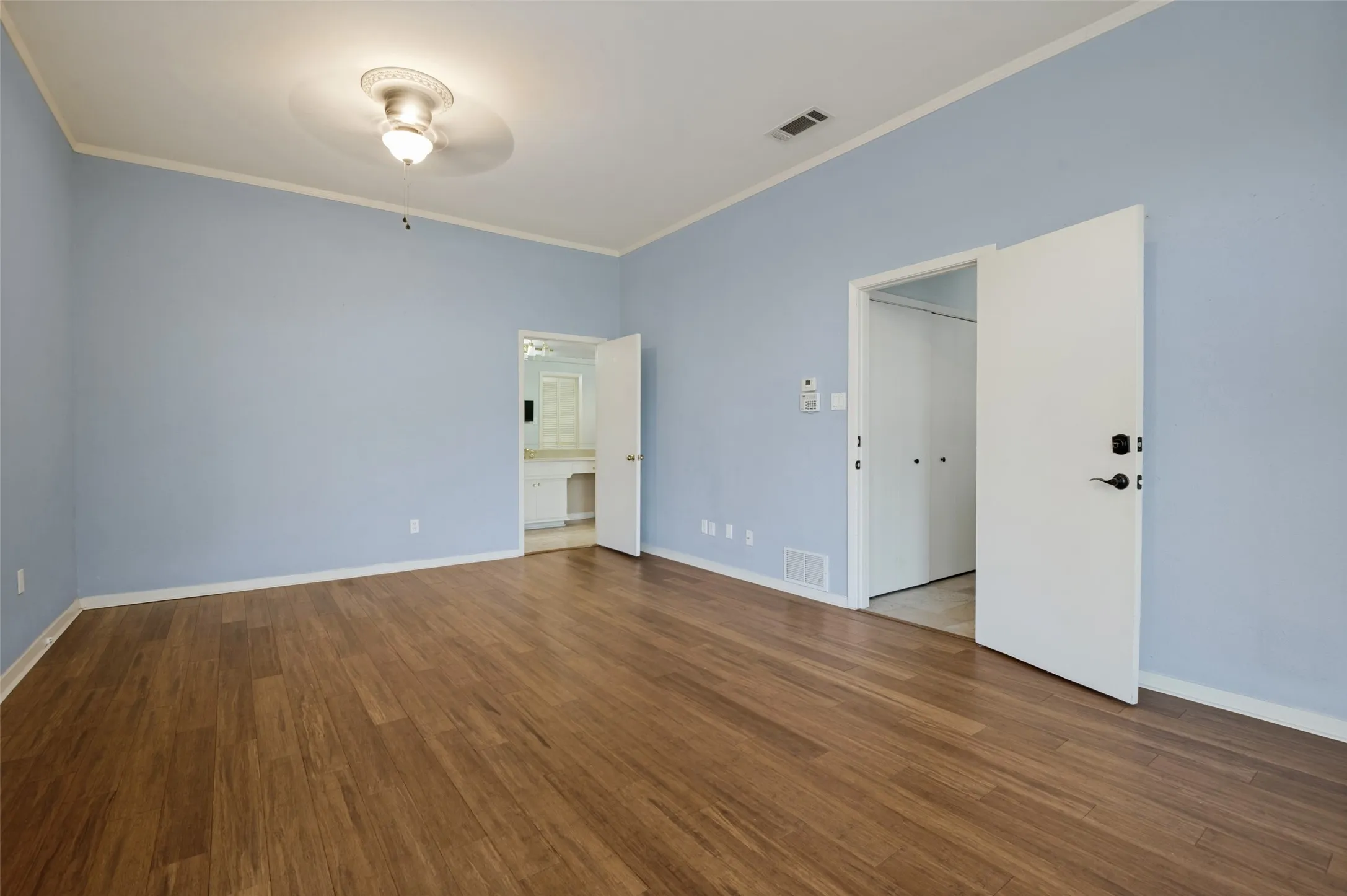 Down Stairs Primary with wood floors/
