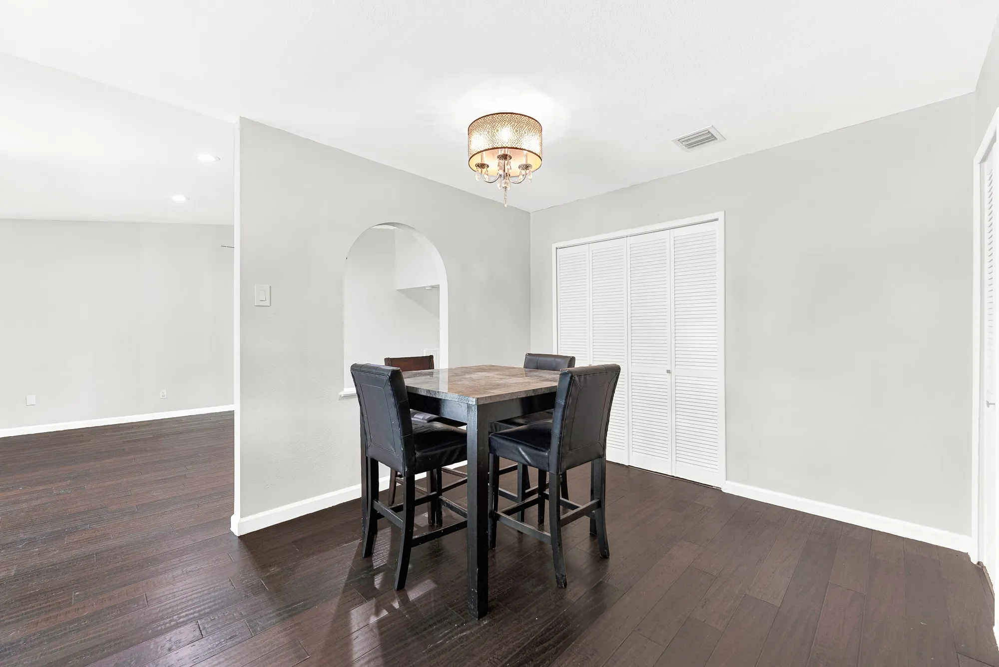 Dining area already has a table and chairs that can stay if you would like. Utility closet behind has full size washer and dryer that also come with the property.