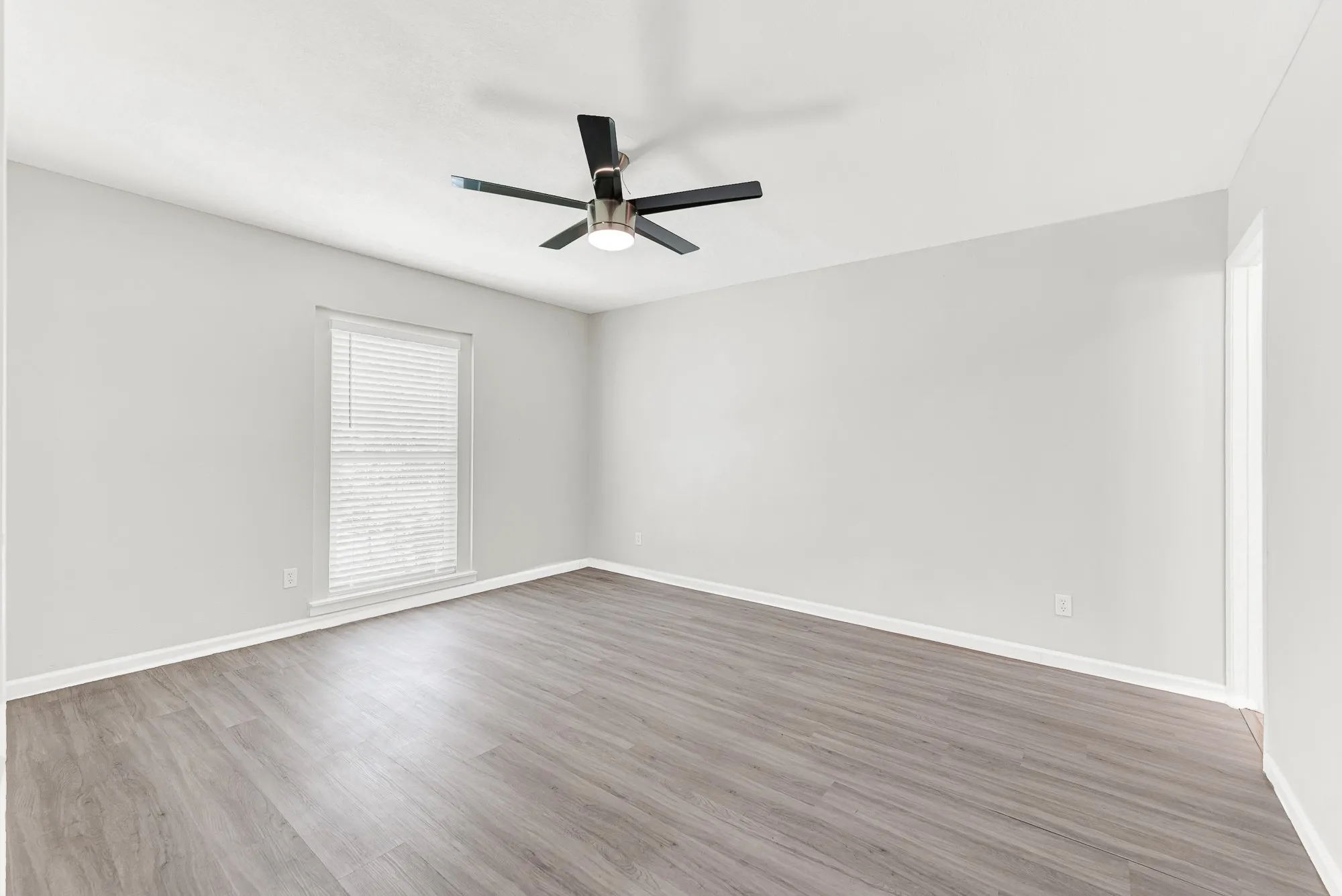 Spacious primary bedroom is separate from other bedrooms.
