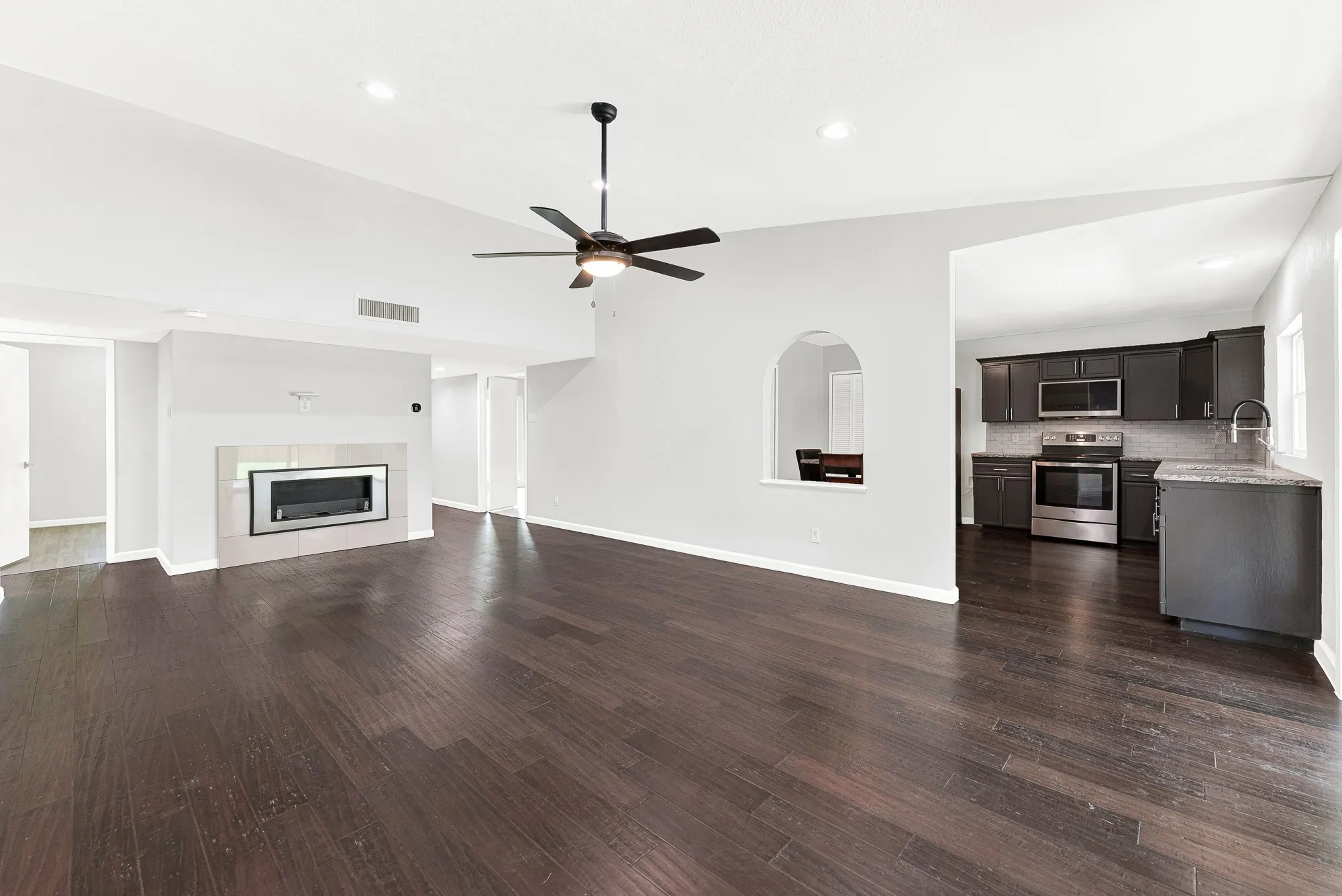 Oversized living room with ethanol fireplace and convenient access to the kitchen.