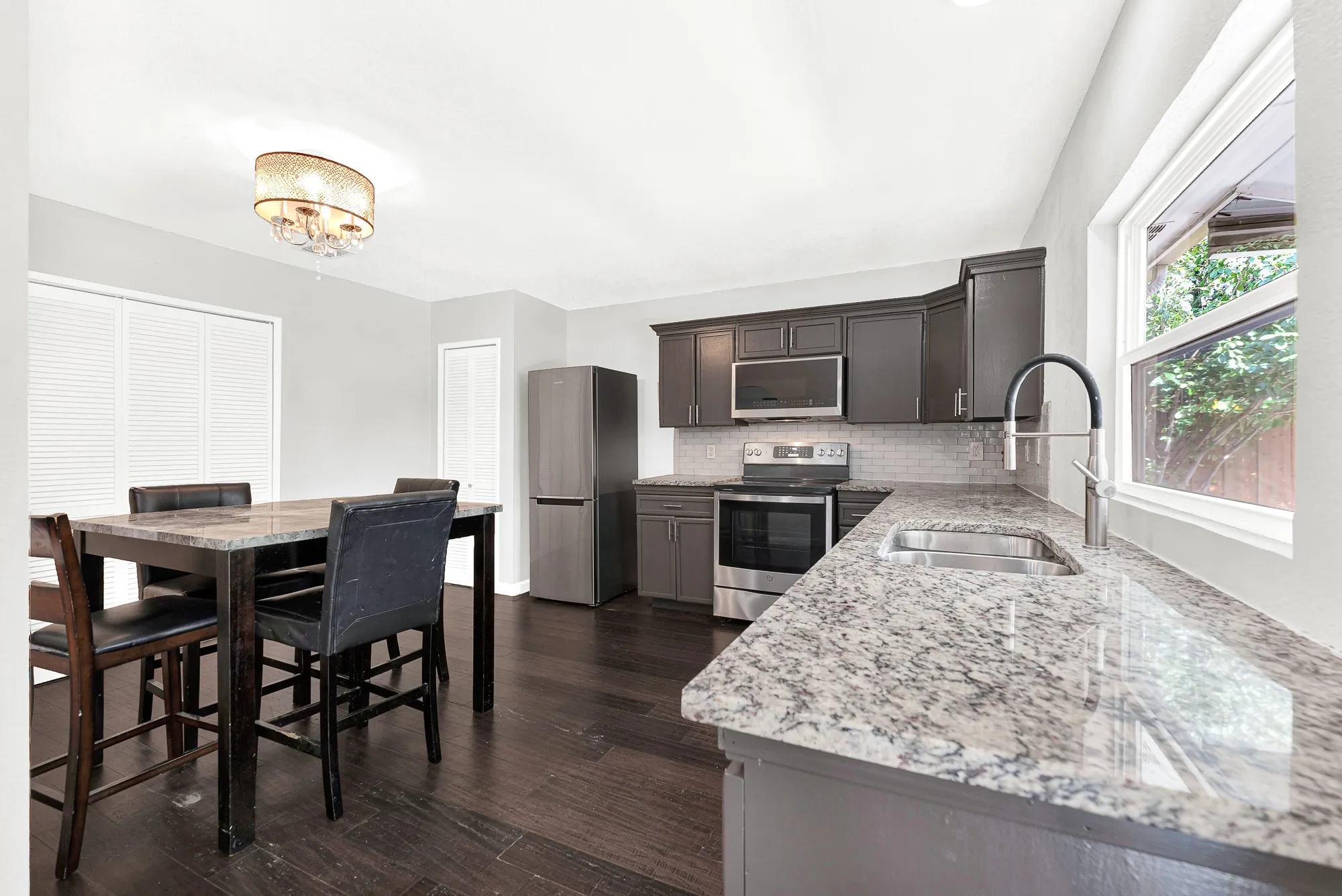 Updated eat-in kitchen  with lots of counterspace on these beautiful granite countertops.