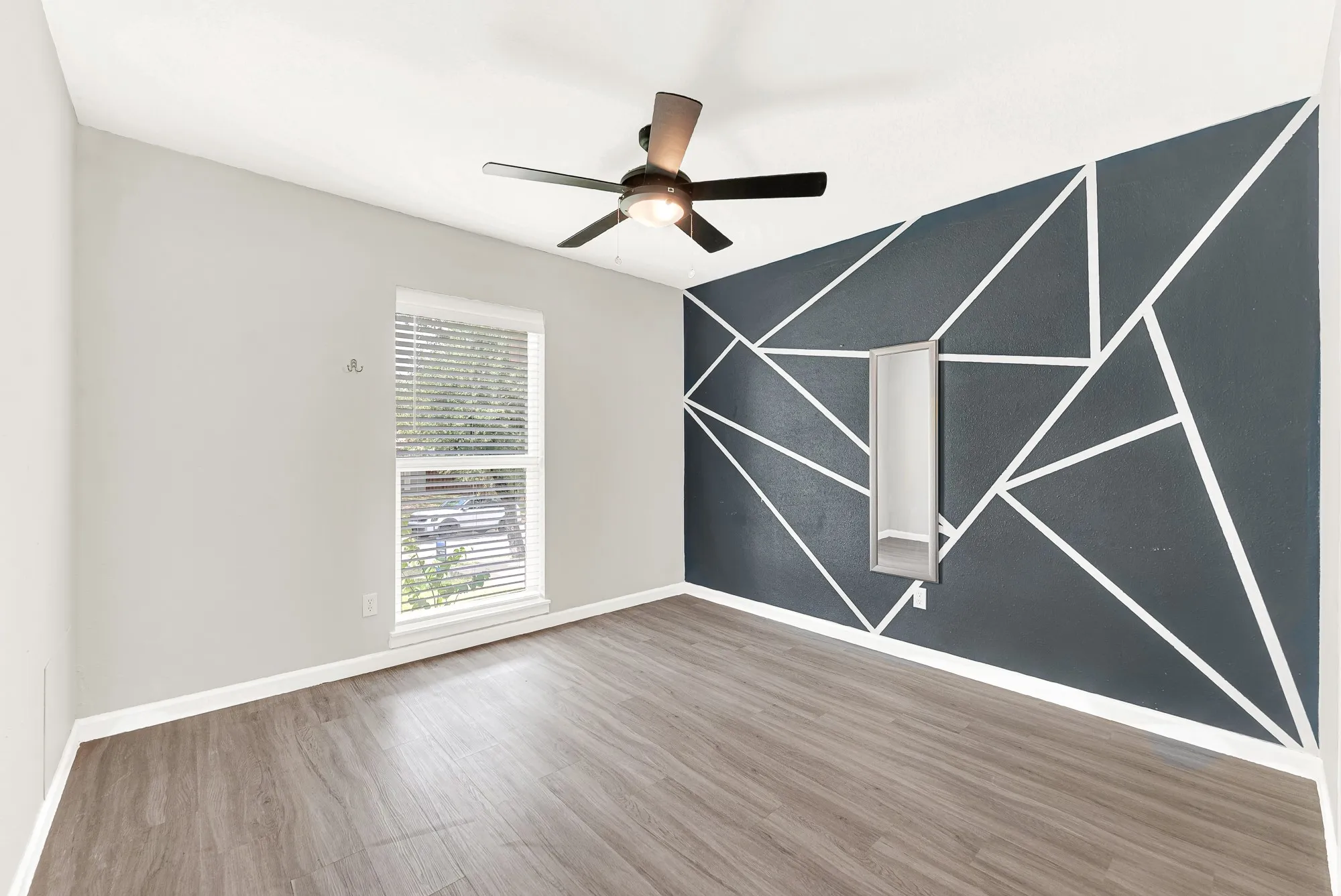 Secondary bedroom with accent wall.