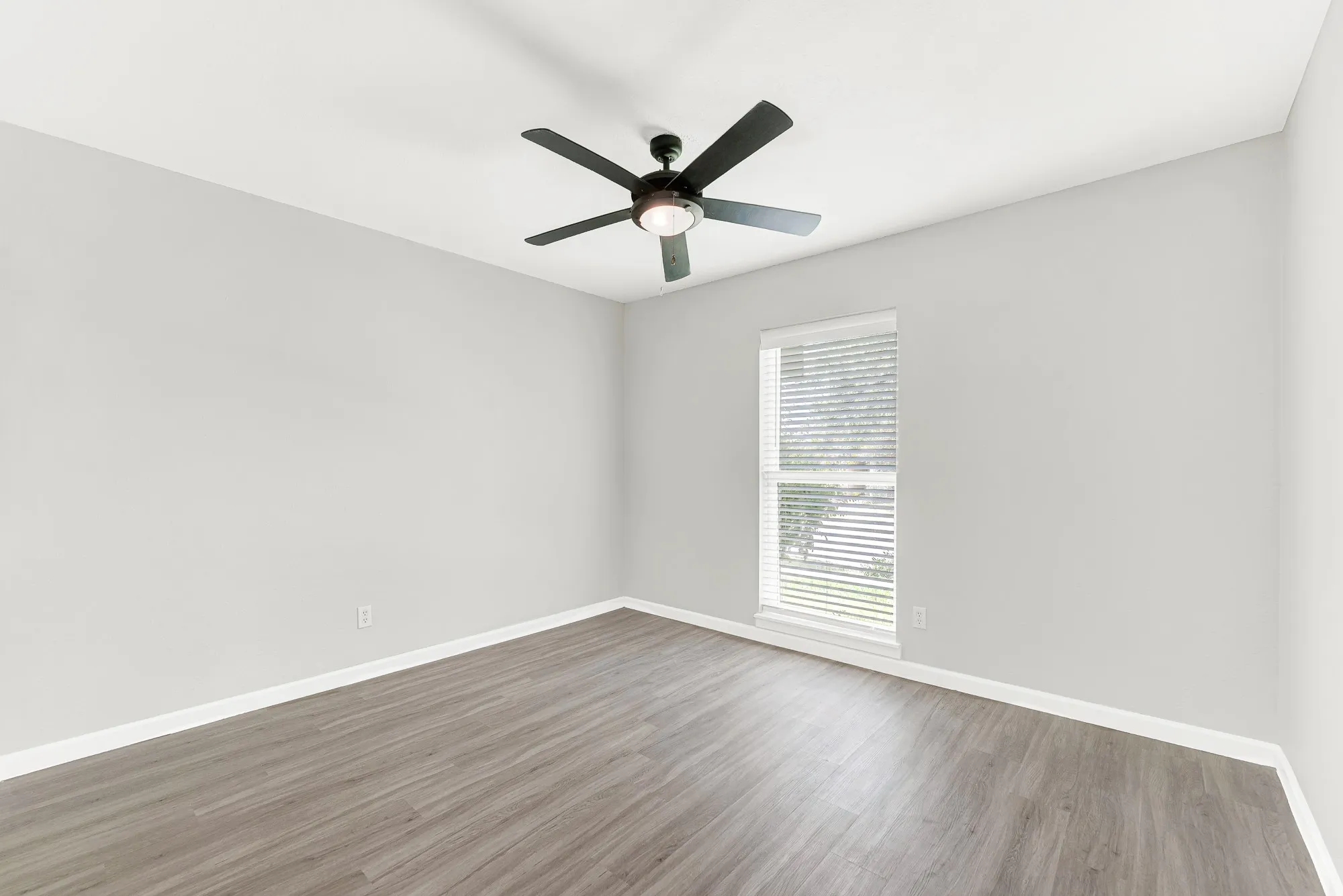 Secondary bedroom is large and has ceiling fan and LVP flooring.