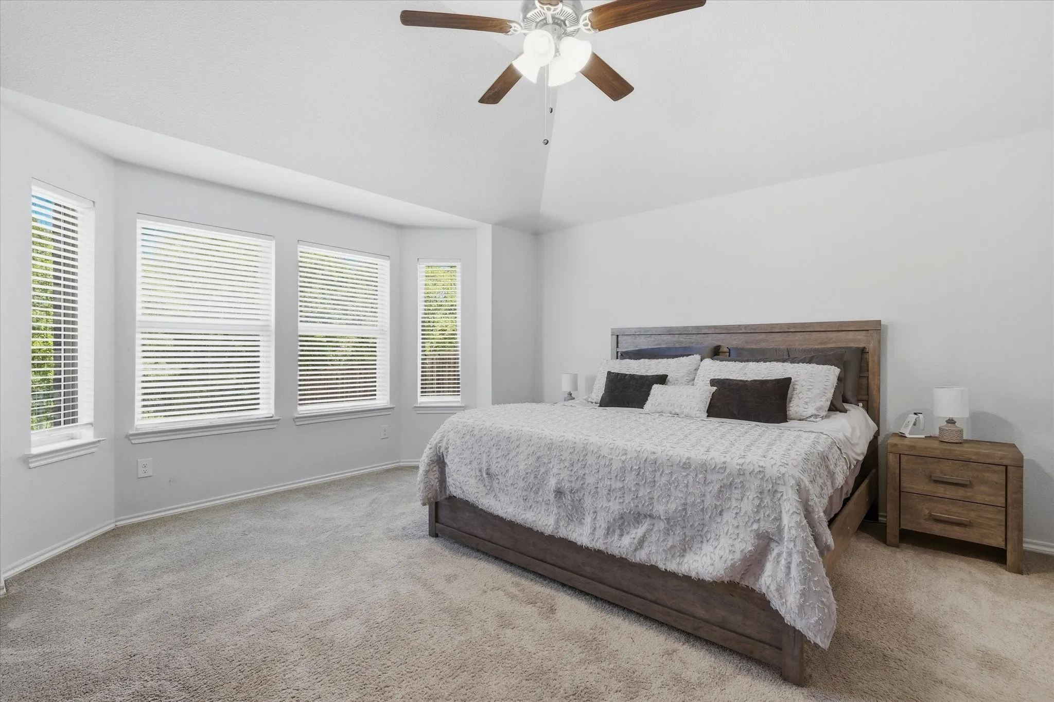 The Primary Bedroom offers a bay window seating area and lovely back yard and greenbelt view.
