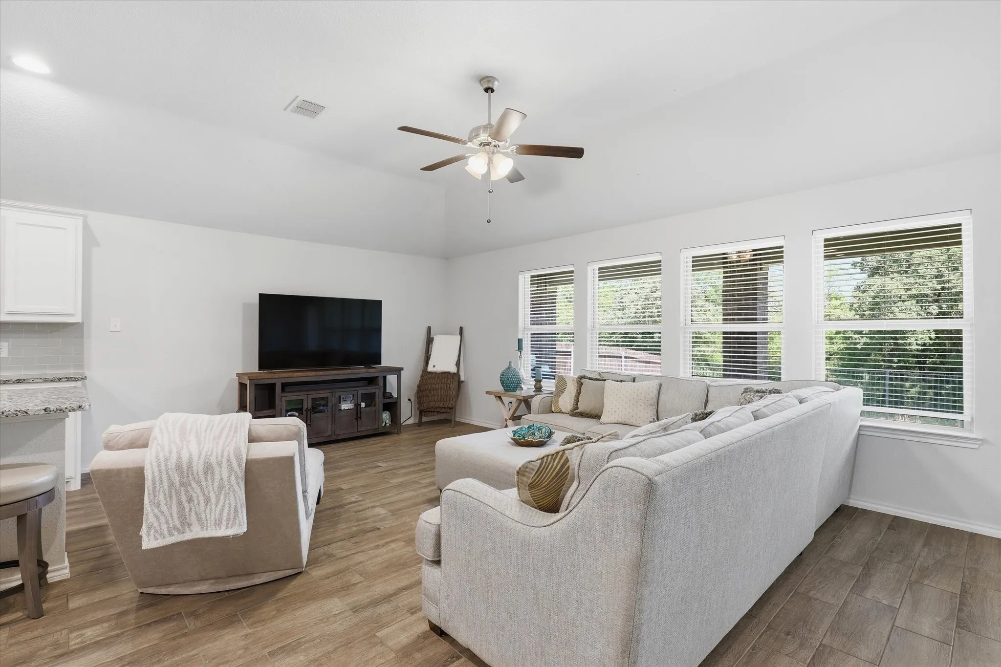 The Family Room offers plenty of space to spread out with back yard and greenbelt views.