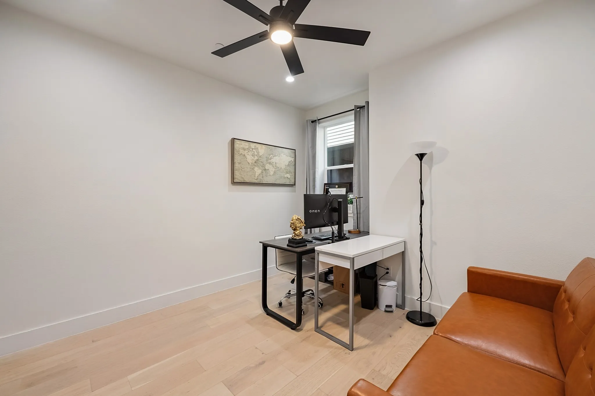 Light wood-finish flooring, recessed lighting, and a ceiling fan with integrated lighting