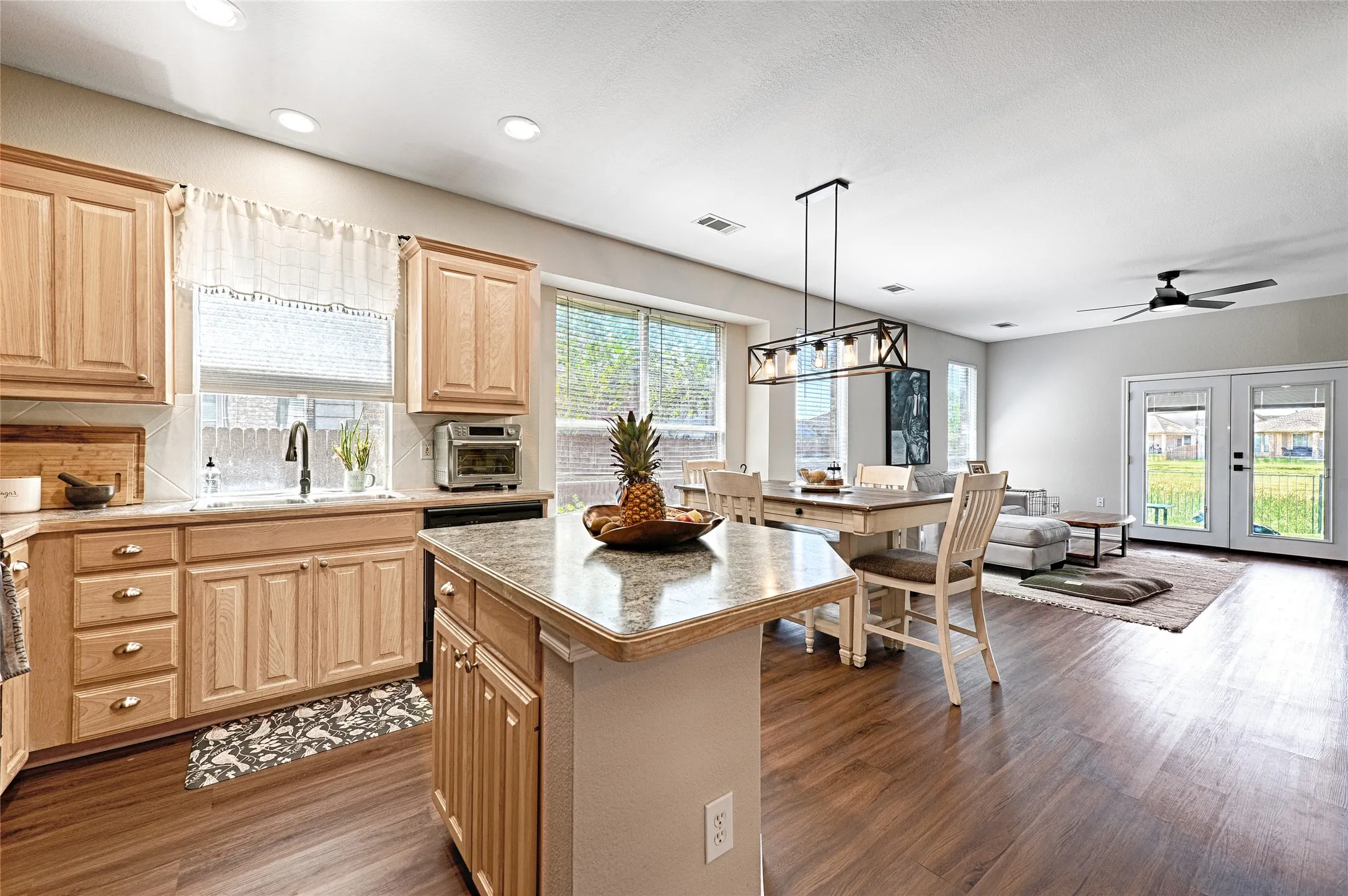 Light cabinets make this kitchen pretty and homey.