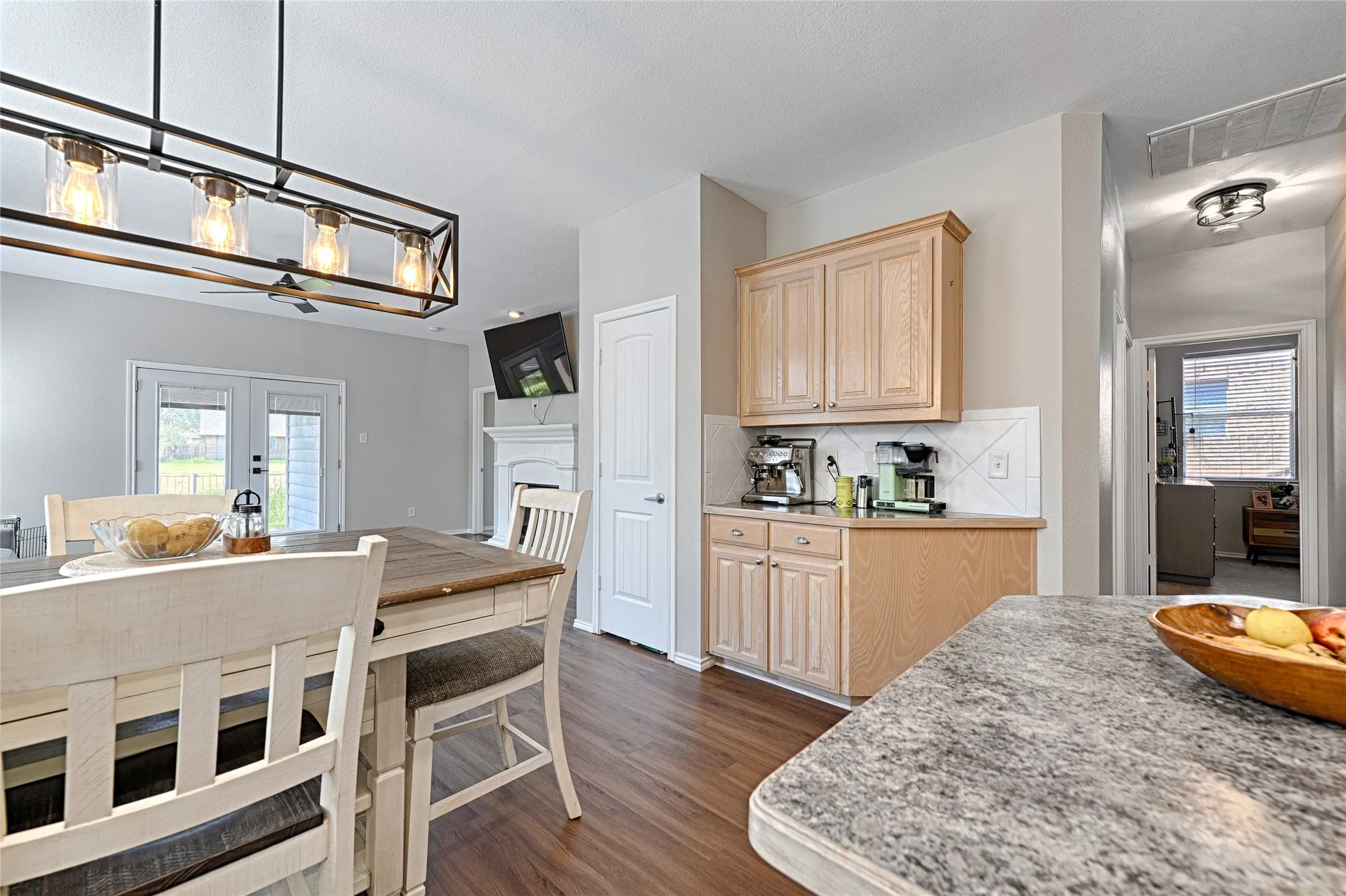 The additional cabinet and counter set up have been utilized as a coffee and espresso bar and would also make a great buffet space.