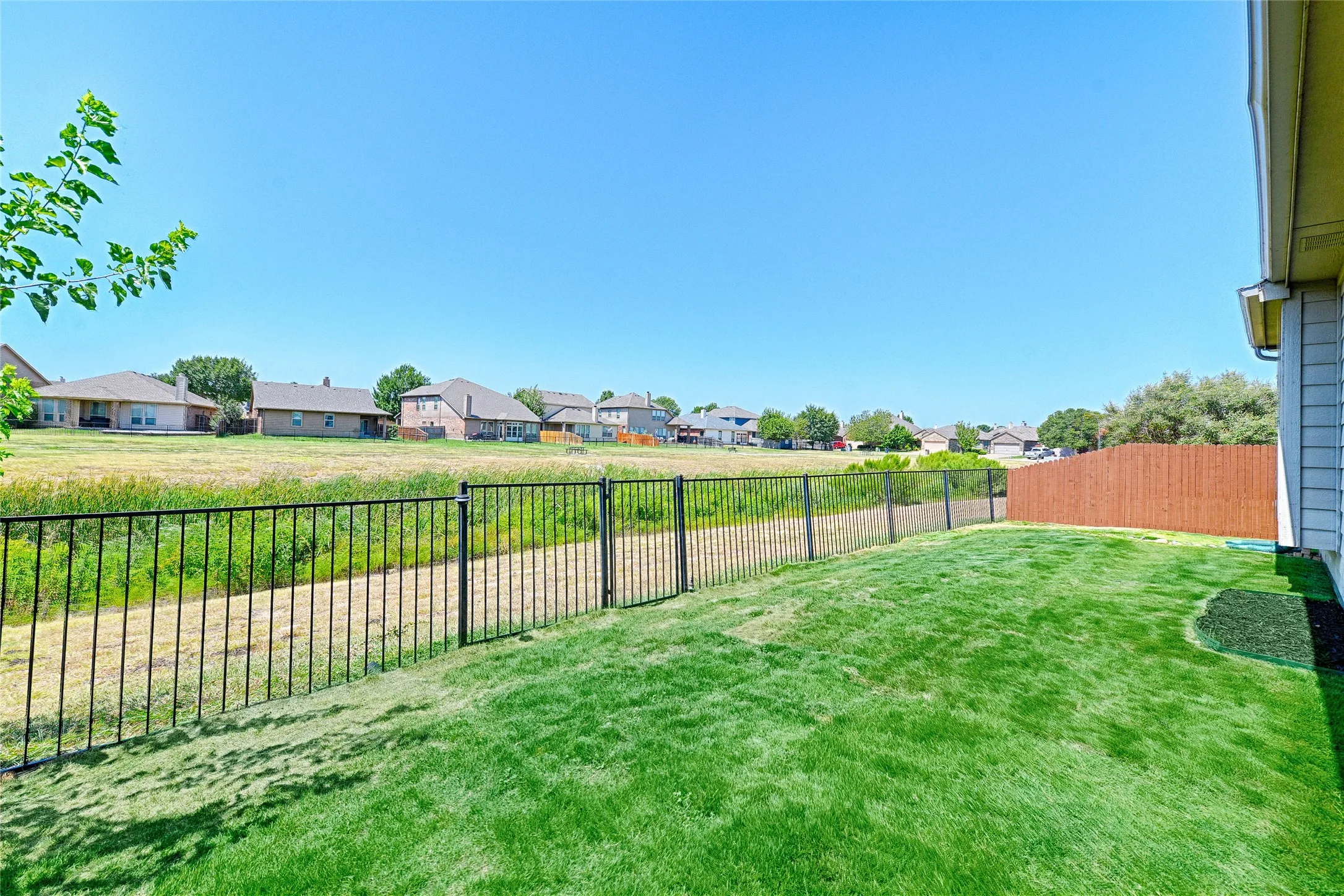 Looking towards the neighborhood greenbelt where you will find a nice, paved path and a playground to one end.