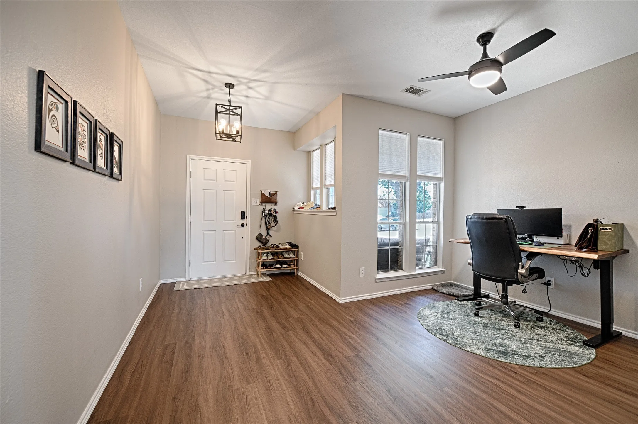 Another angle looking back towards the front door and space used as an office, also with some great windows.