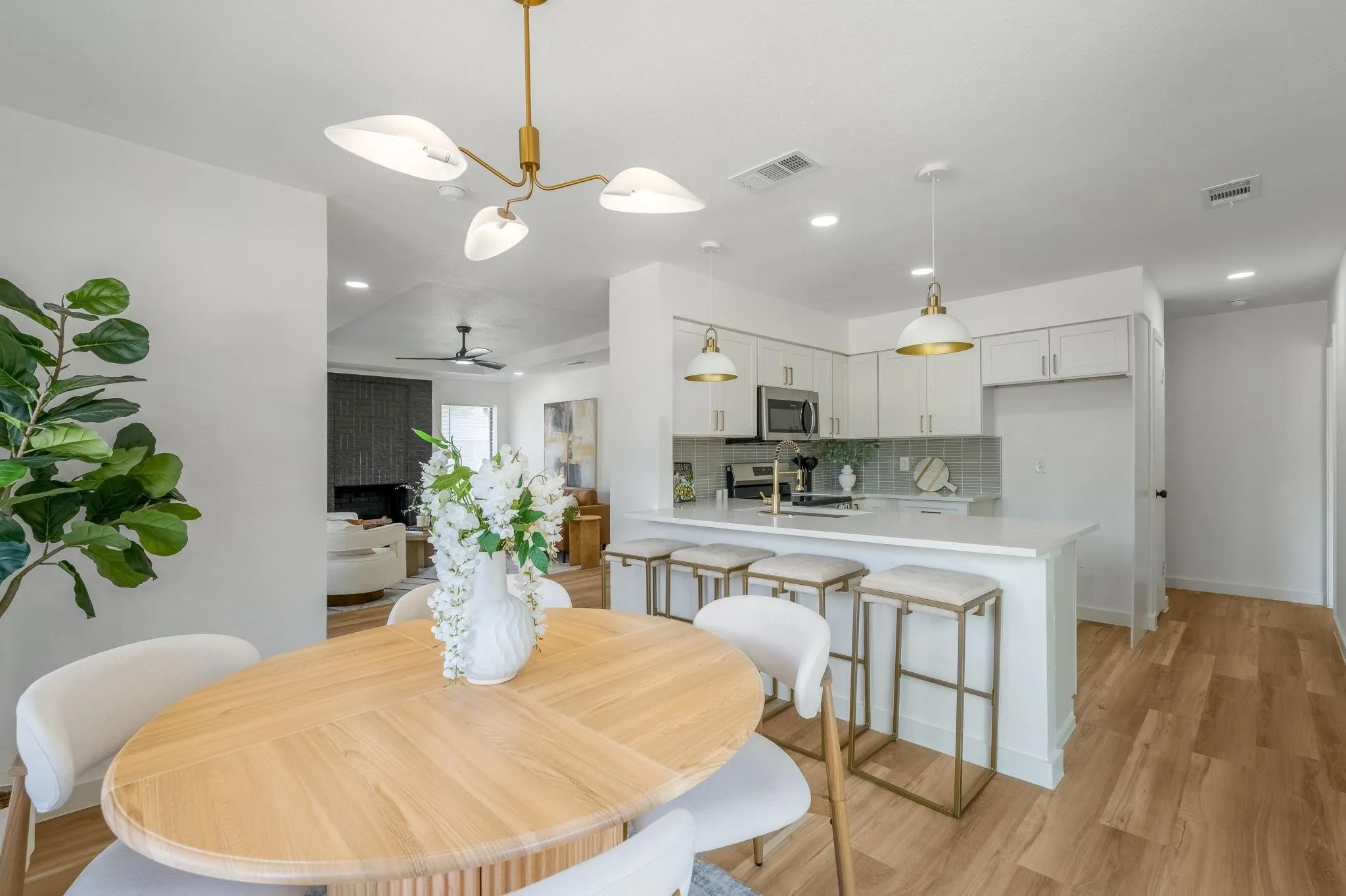 Open-concept living space featuring a kitchen island, pendant lighting, recessed lighting, and wood-finish flooring