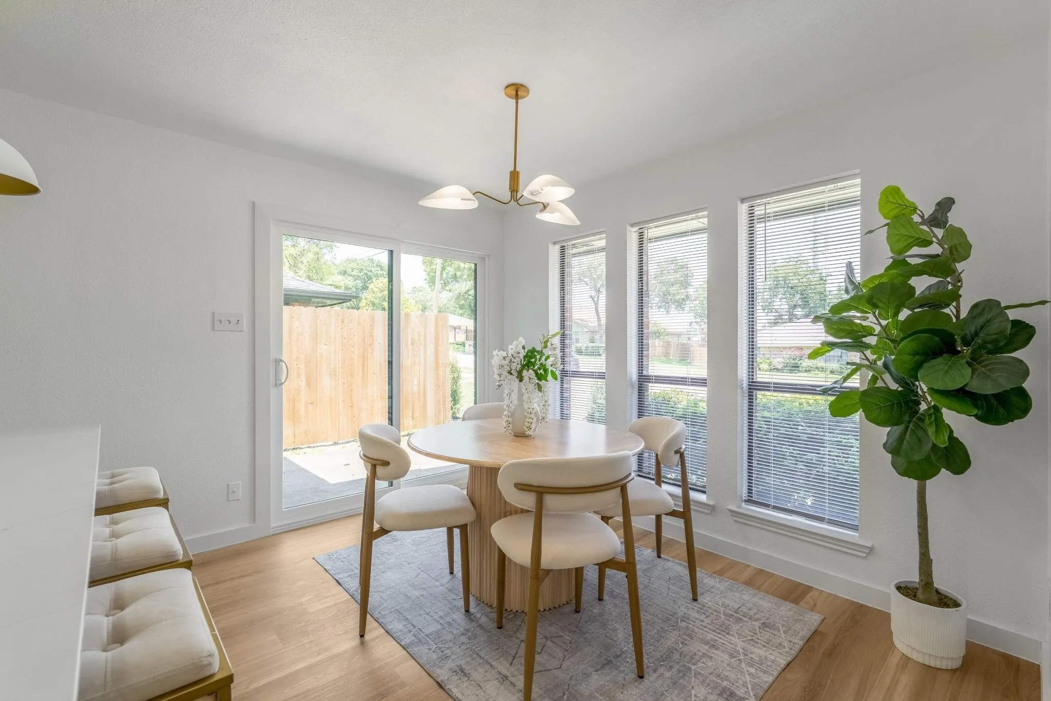 Recessed lighting, wood-finish flooring, white walls, multiple windows with blinds, and sliding glass door