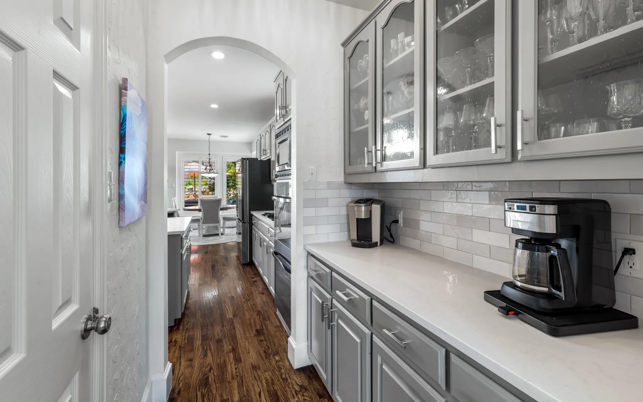 Butler's pantry has lots of cabinet and counter space for entertaining. The door to the right leads to a large walk-in pantry.