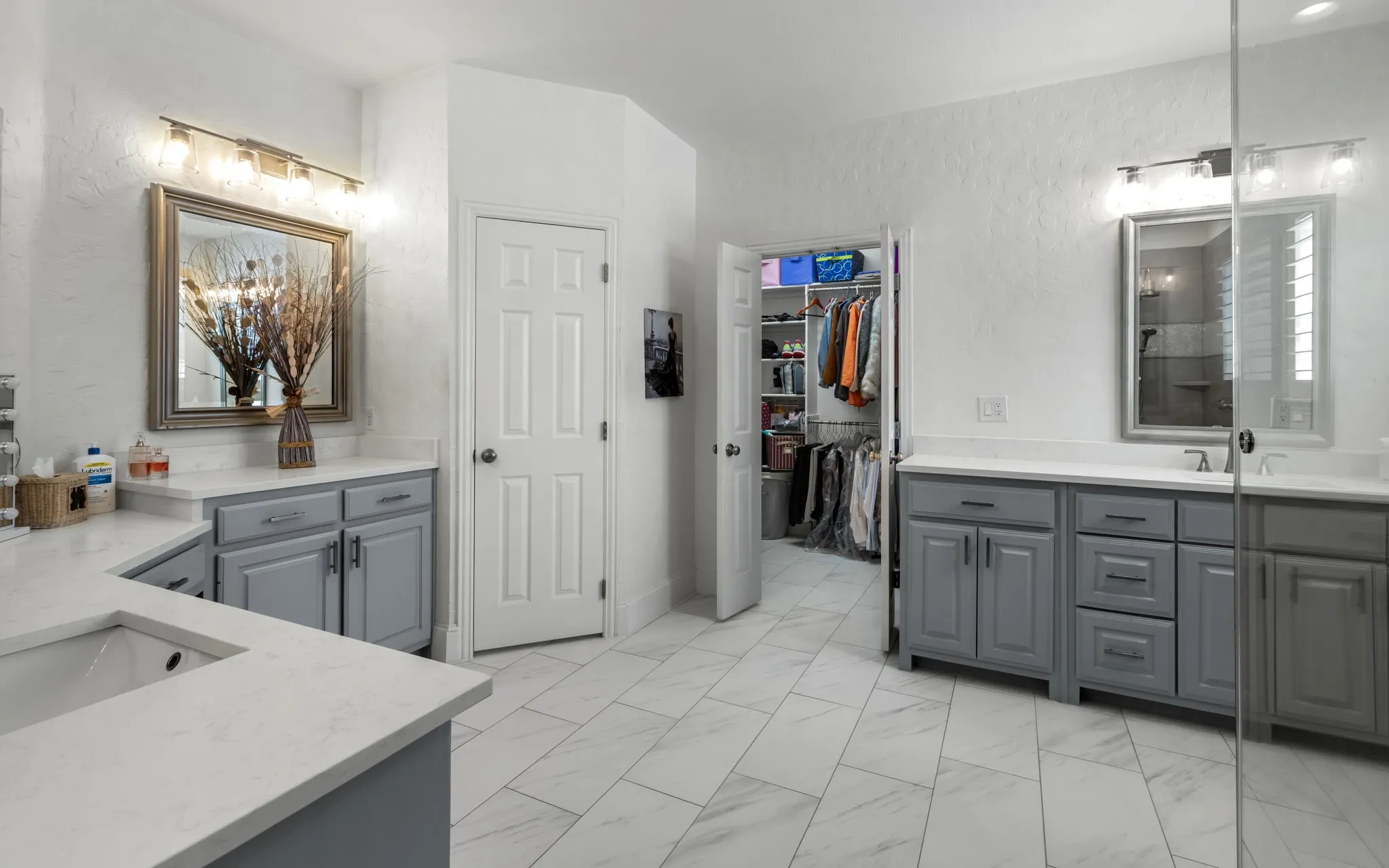 Large primary ensuite bath has plenty of counter space (newer quartz), flooring and a large updated walk-in shower.