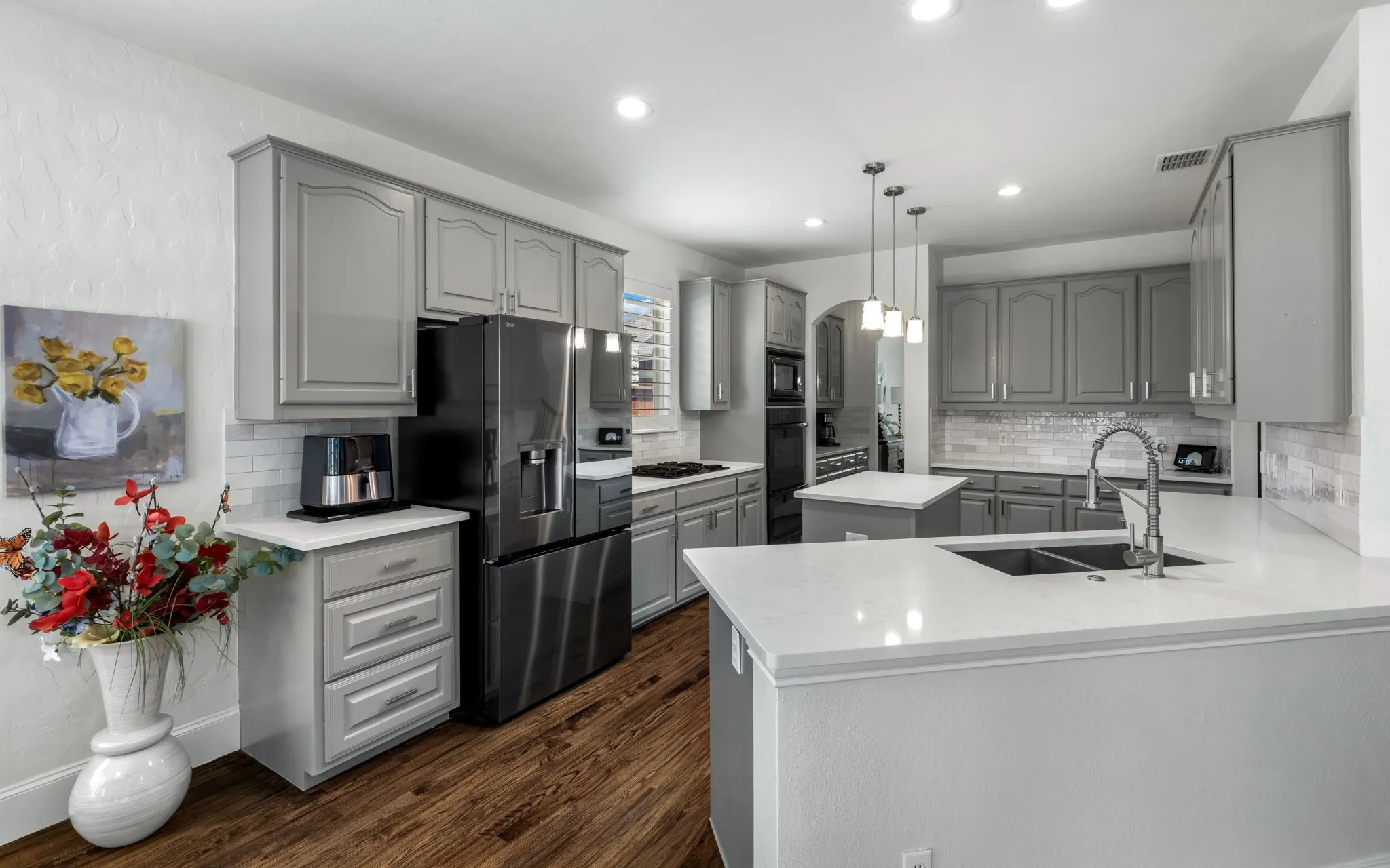 The well equipped kitchen features newer quartz counters, double ovens and easy access to the formal dining through the butler's pantry.