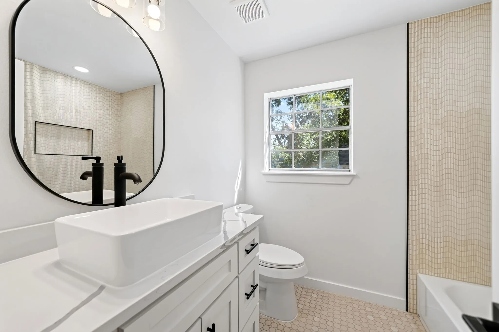 White rectangular vessel sink with matte black fixtures