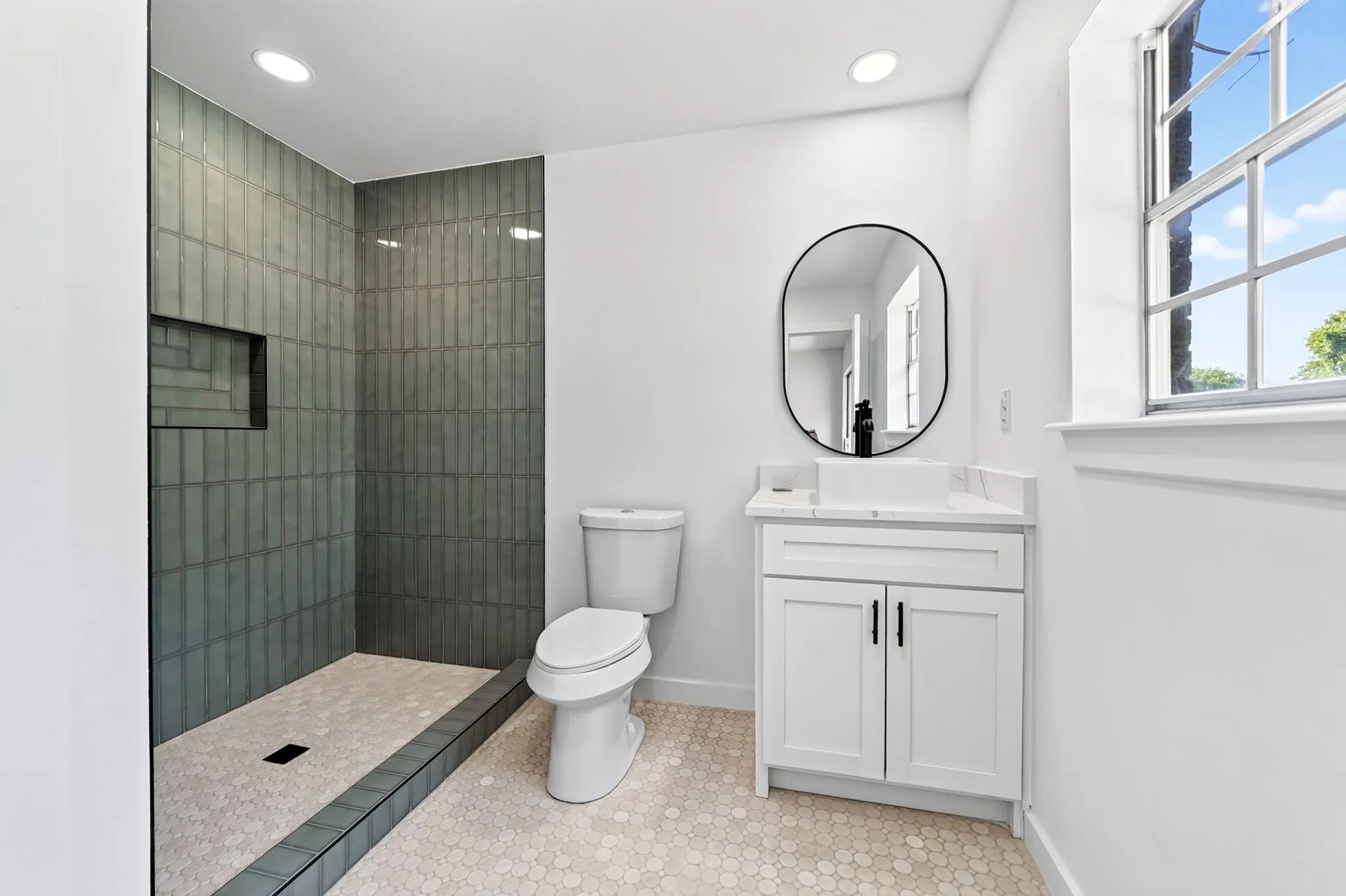 Walk-in shower with vertical tile detailing and built-in niche