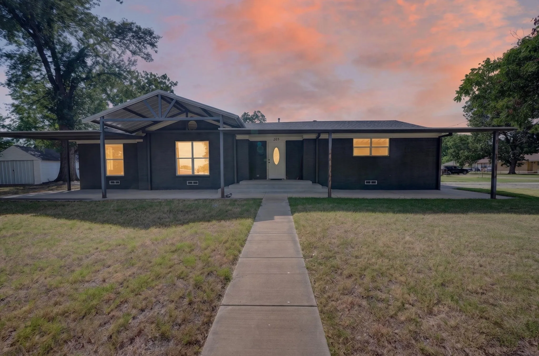 Single-story residence with a covered entry, covered patio area, and an additional covered carport structure