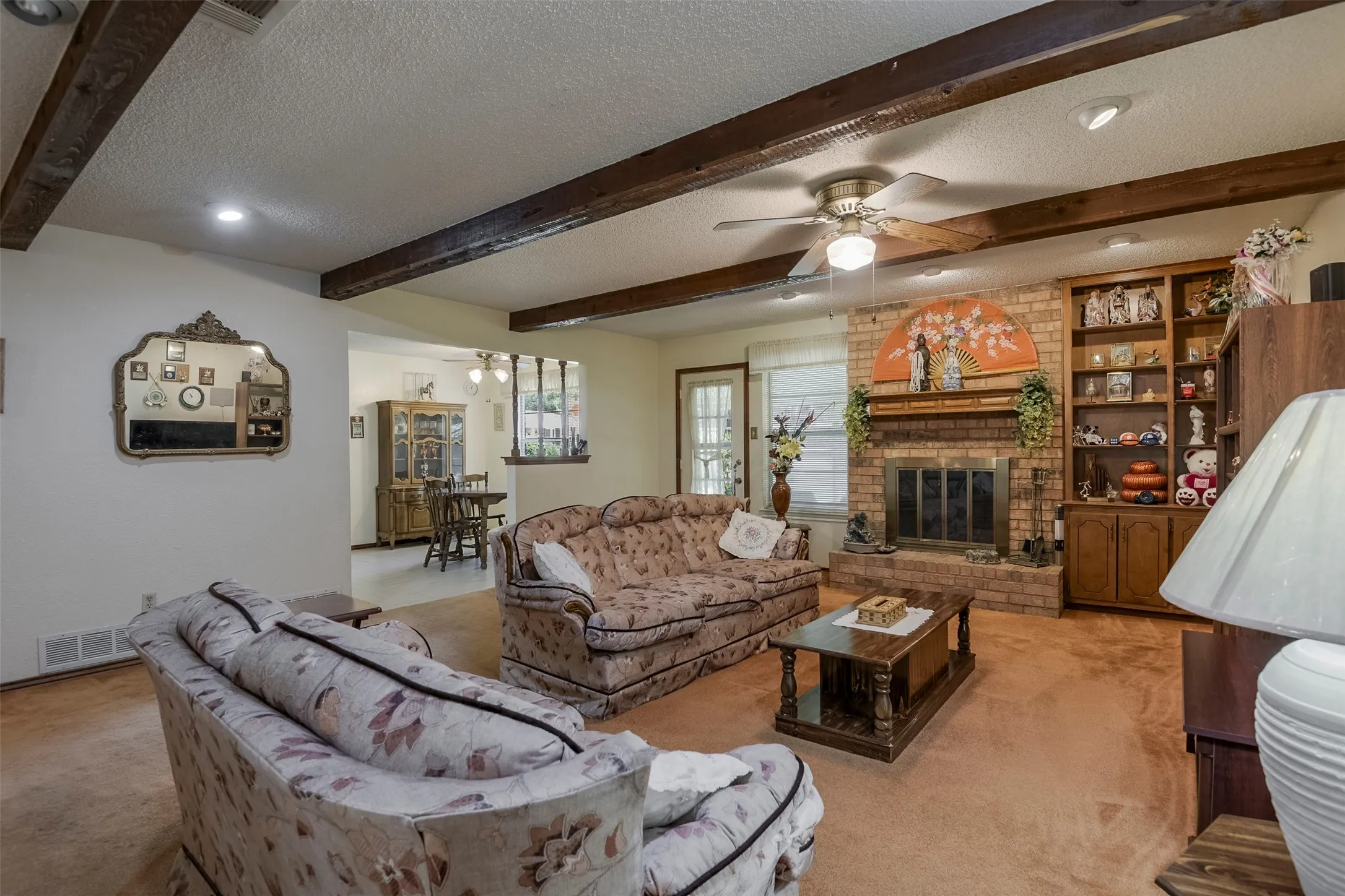 Texas-styled woodburning fireplace with raised hearth adds warmth, character and architectural dimension while beautifully anchoring the open, flowing floorplan.  It's an inviting setting for relaxed family living and effortless entertaining.