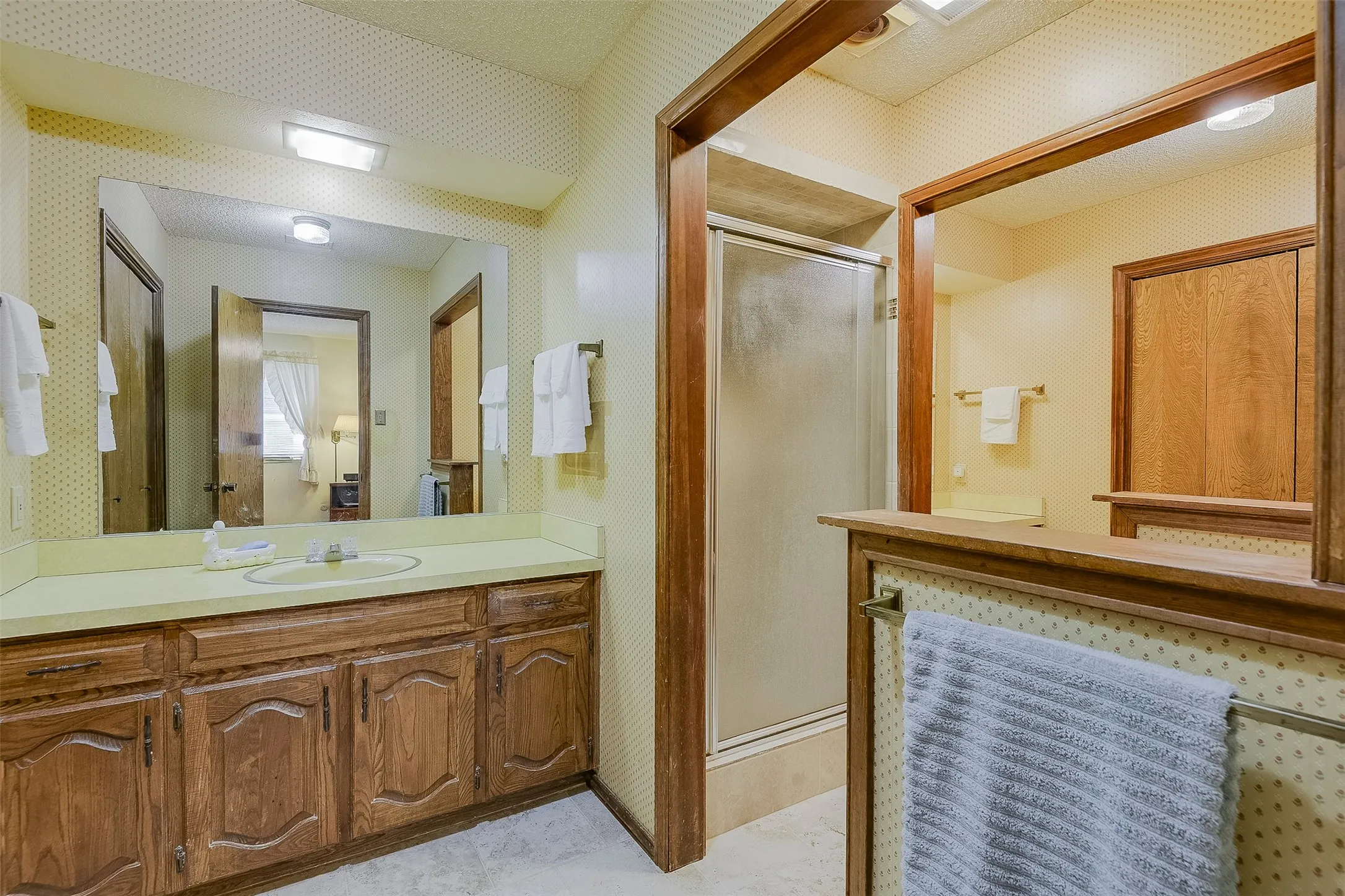 Dual extended dressing areas with cabinets below create a well-appointed, highly functional ensuite bath with walk-in shower adding relaxing comfort and convenience.