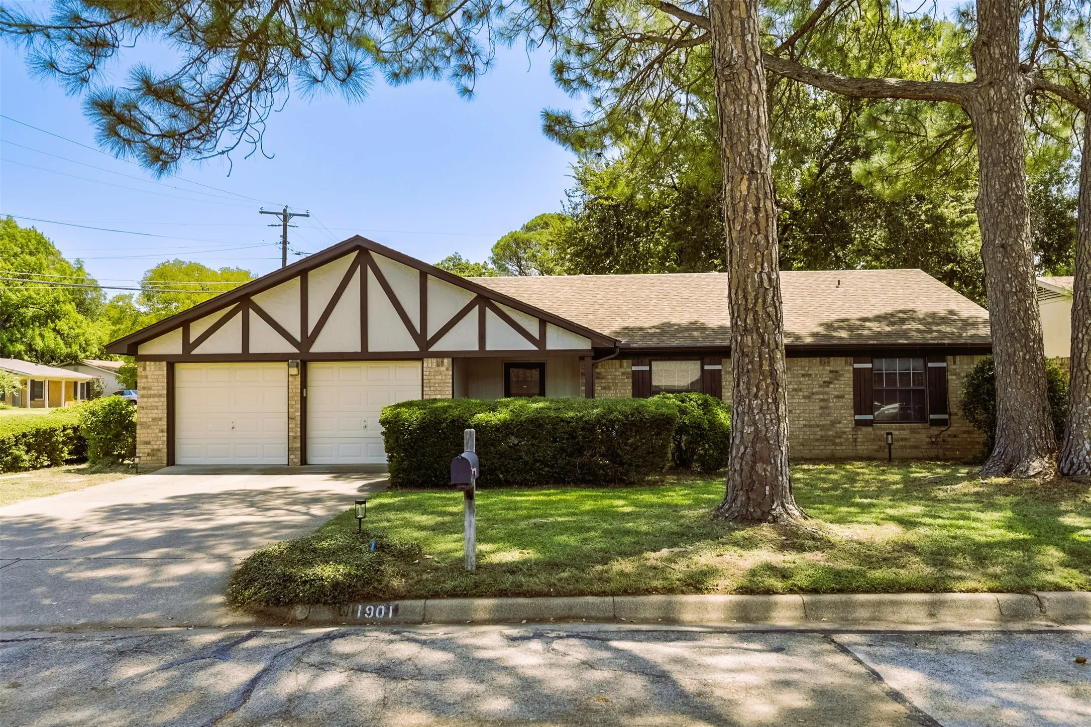 Lush, verdant backdrop shaded by towering signature trees frames and accentuates this home's timeless style.