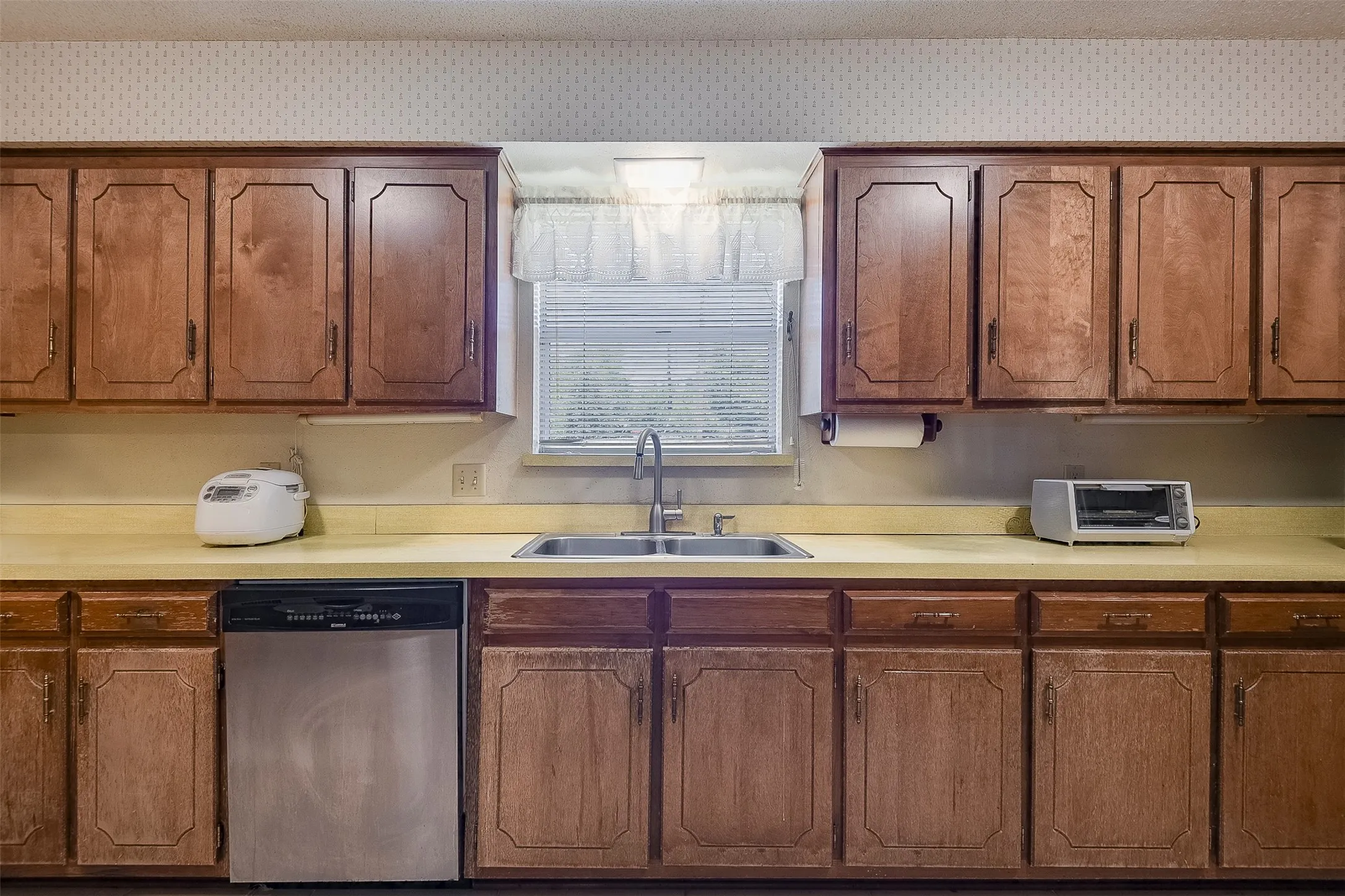 Expansive kitchen delivers an abundance of prep space and exceptional storage, creating a coveted workspace for your family chef.  Traditional window positioned above the dual sink brings in natural light while adding connection to the outdoors.