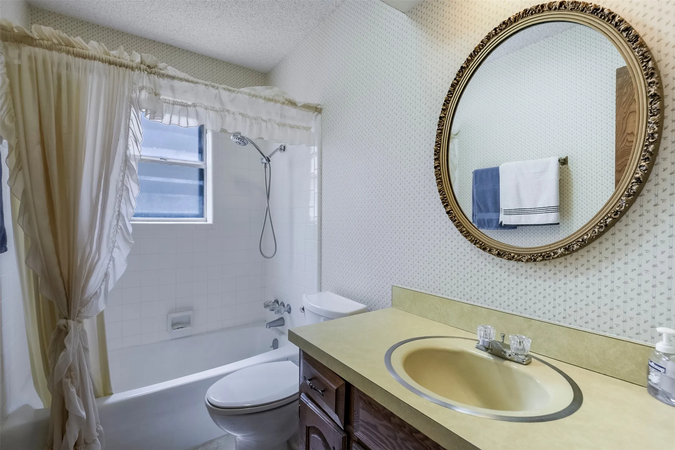 Traditionally styled bathroom is conveniently located adjacent to the auxiliary bedrooms.  Tub-shower combination offers everyday versatility for family members of all ages, making bath time easy and fun for the little ones.