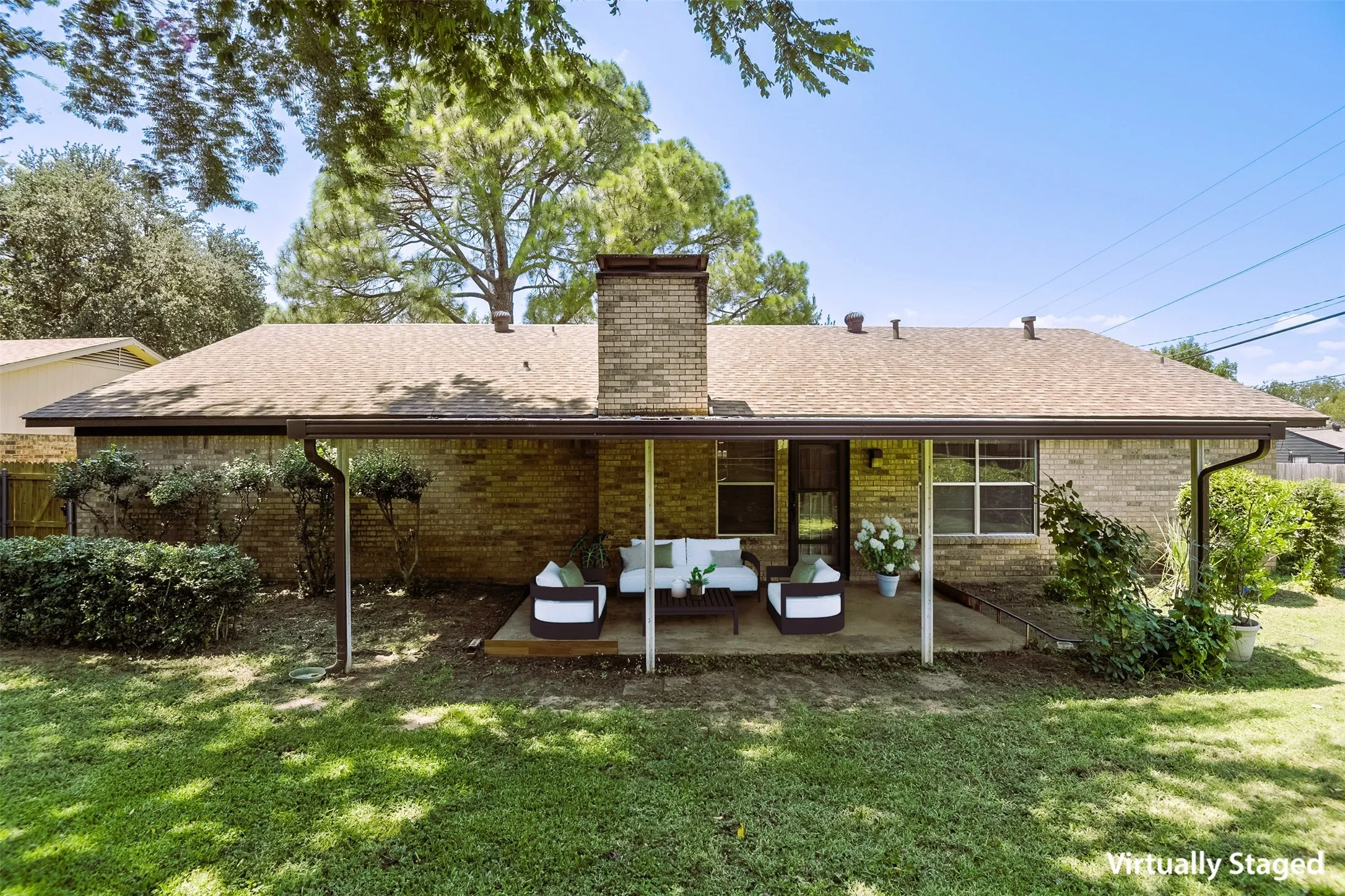 Eastern exposure showcases an inviting covered patio virtually staged to show off this wonderful spot for gathering with family and friends to enjoy an afternoon BBQ or evening beverages.  Party lights anyone?