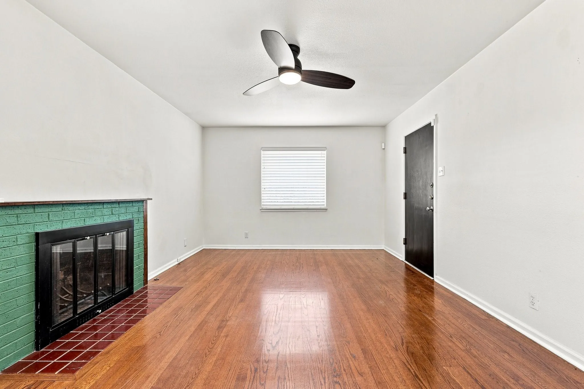 Decorative gas fireplace and stylish ceiling fan.