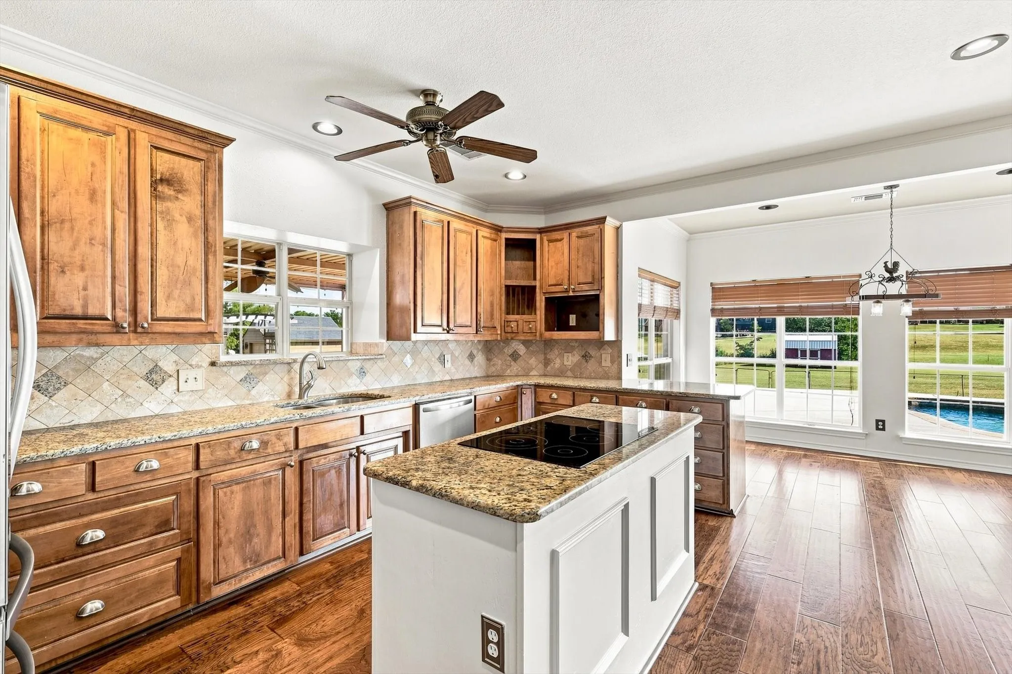 Imagine creating memories in this kitchen. Counter space for daily use and perfect for entertaining.  Location to exterior and pool make this the central heart of the home.