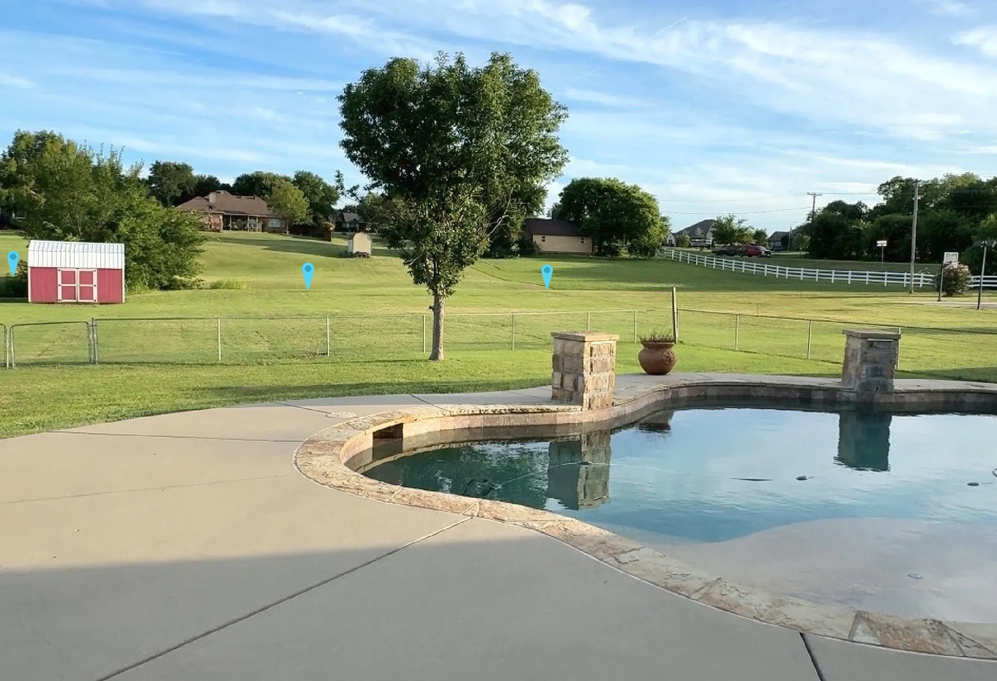View of your 1.23 acres. pool. The sunsets are gorgeous. Blue pins are the rear boundary.  Feel the stress melt away.