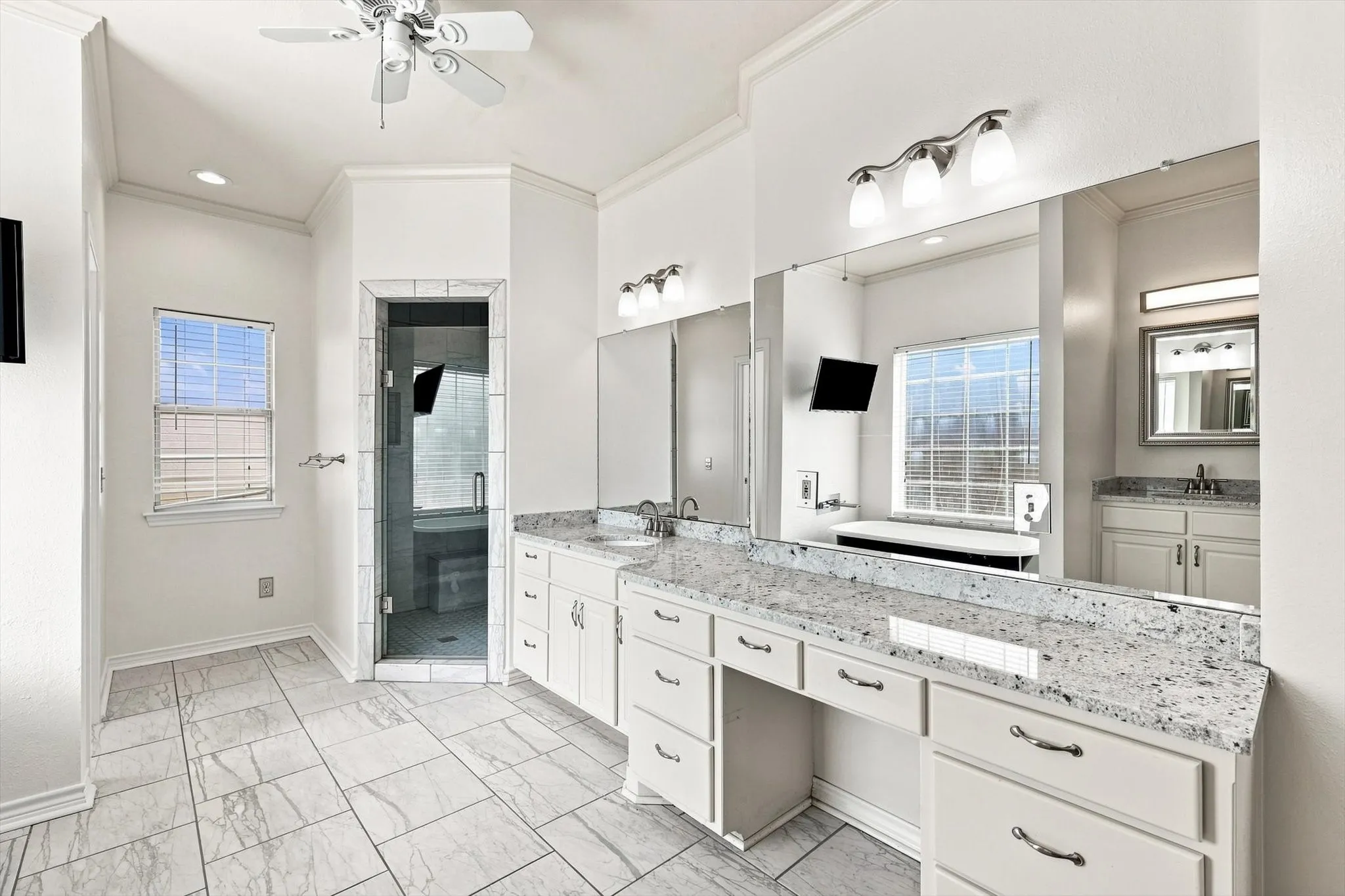 Double vanity in addition to the single just shown.  Newly painted and fresh. Color brings out the shine and glow of the granite.