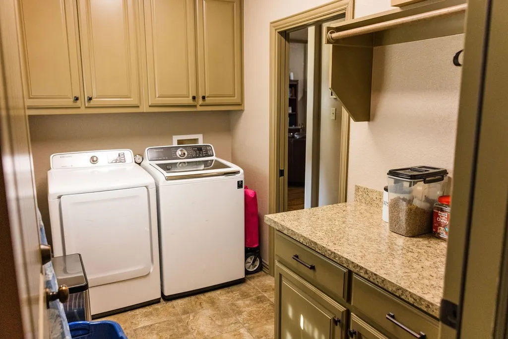 Built-in cabinetry with dark hardware, solid surface countertops, and tile flooring