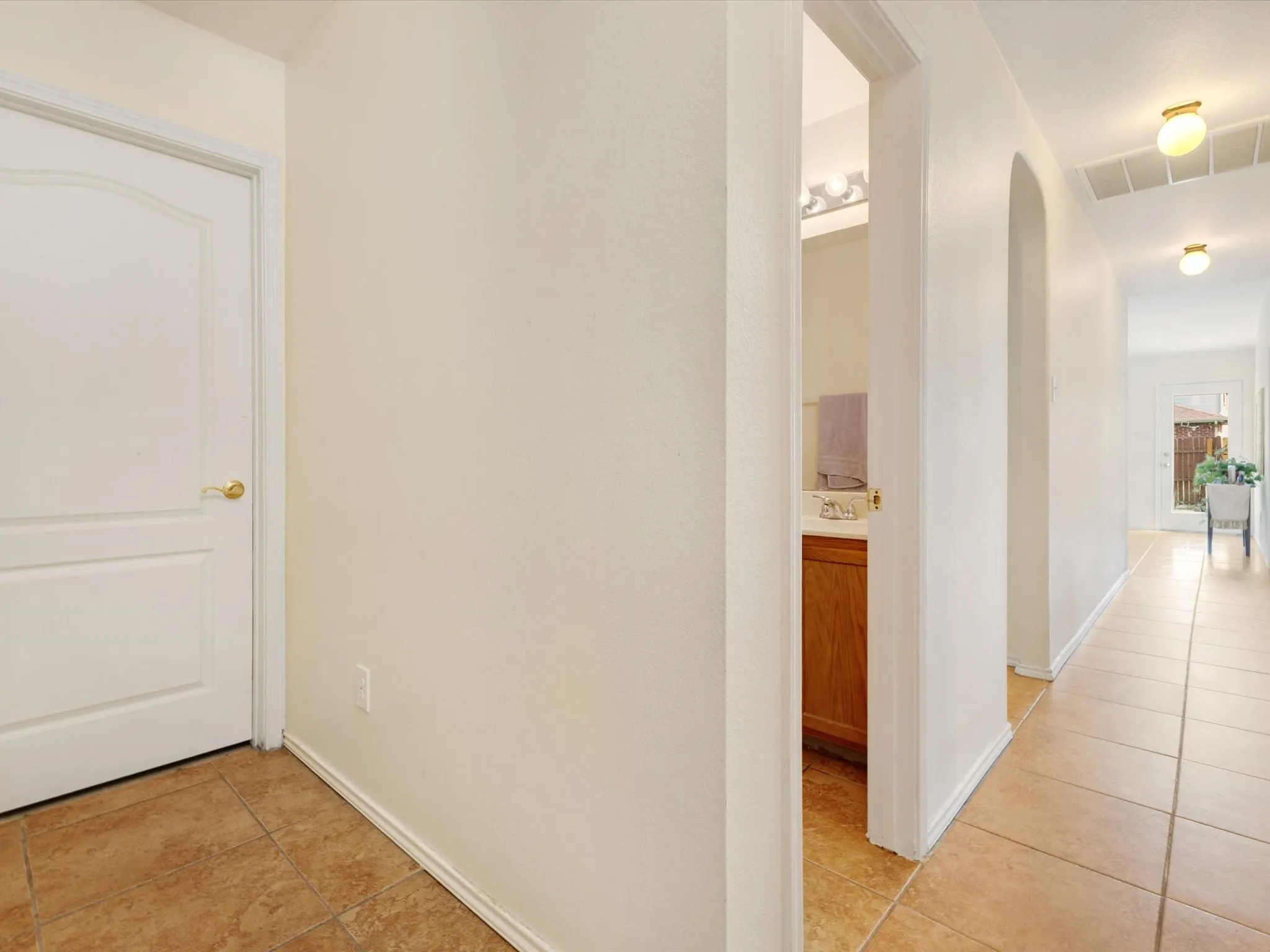 Tile flooring throughout the hallway