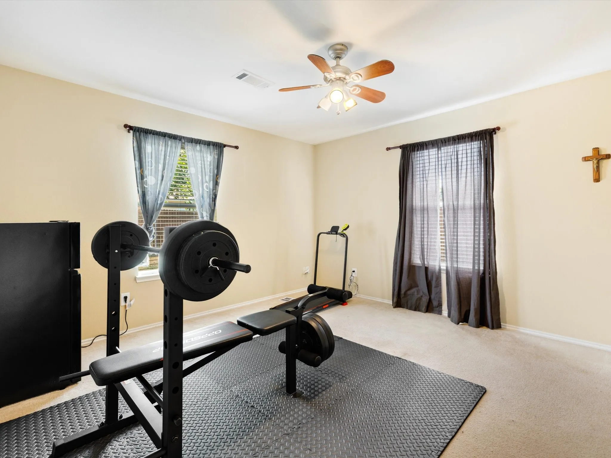 Recessed lighting, wood-finish ceiling fan, and two windows