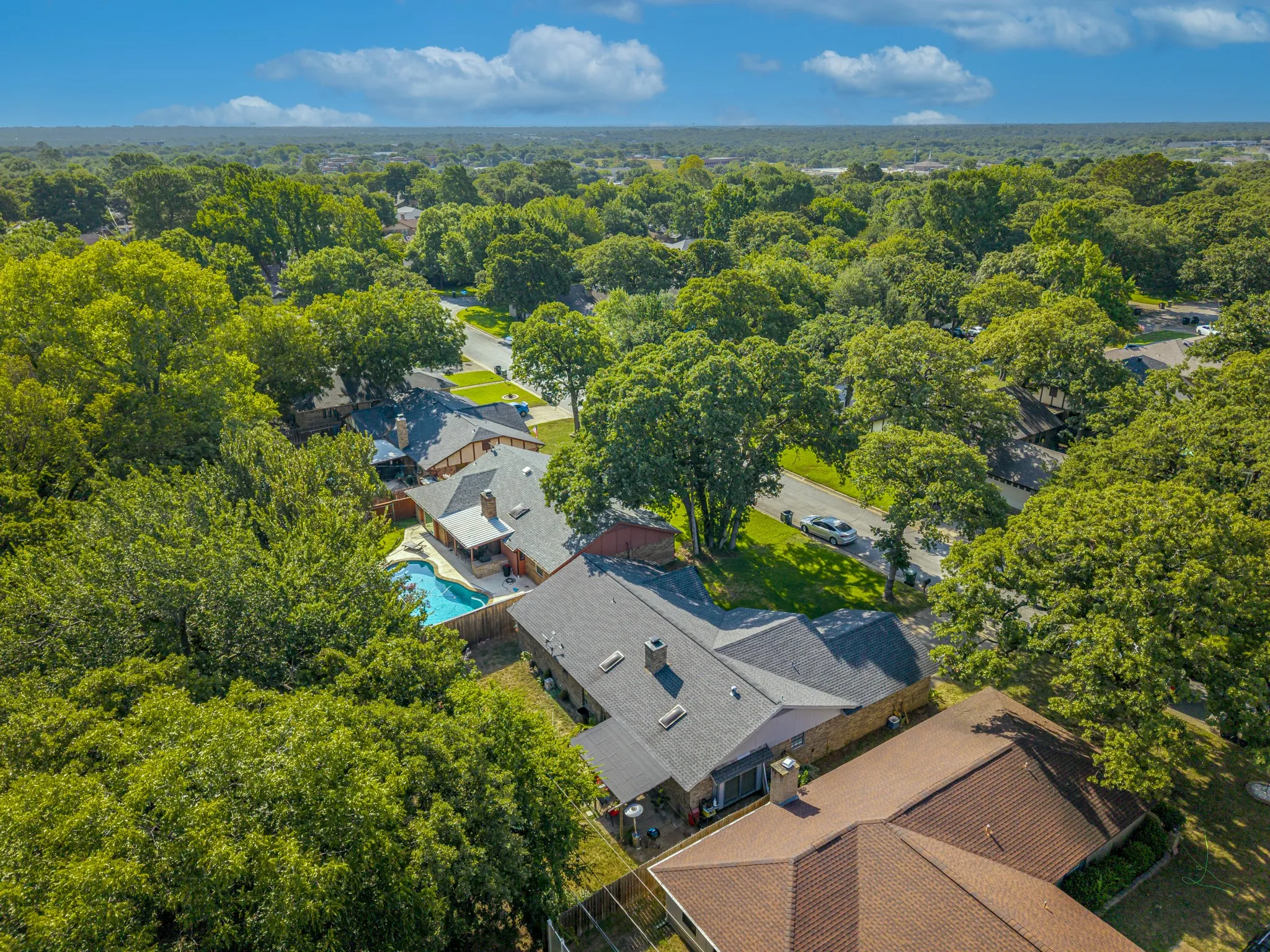 Expansive backyard with a built-in swimming pool and covered patio
