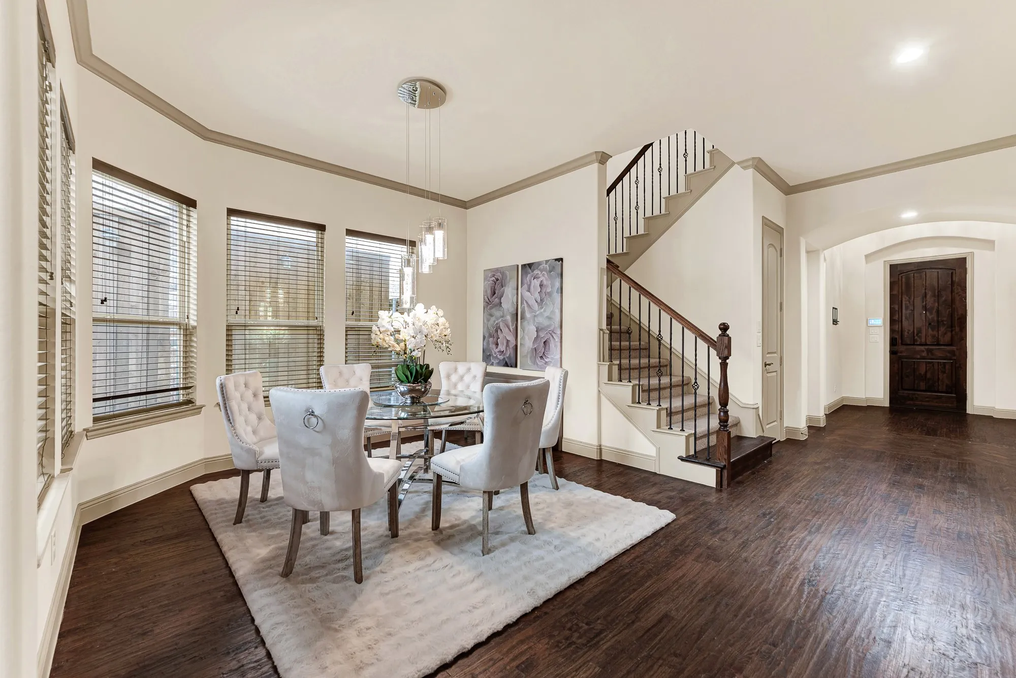 Graceful archways connect seamlessly to the open staircase, creating an airy sense of volume throughout the main living level. It is naturally suited for lively holiday celebrations where conversation drifts effortlessly from welcoming guests at the foyer to gathering around dinner.