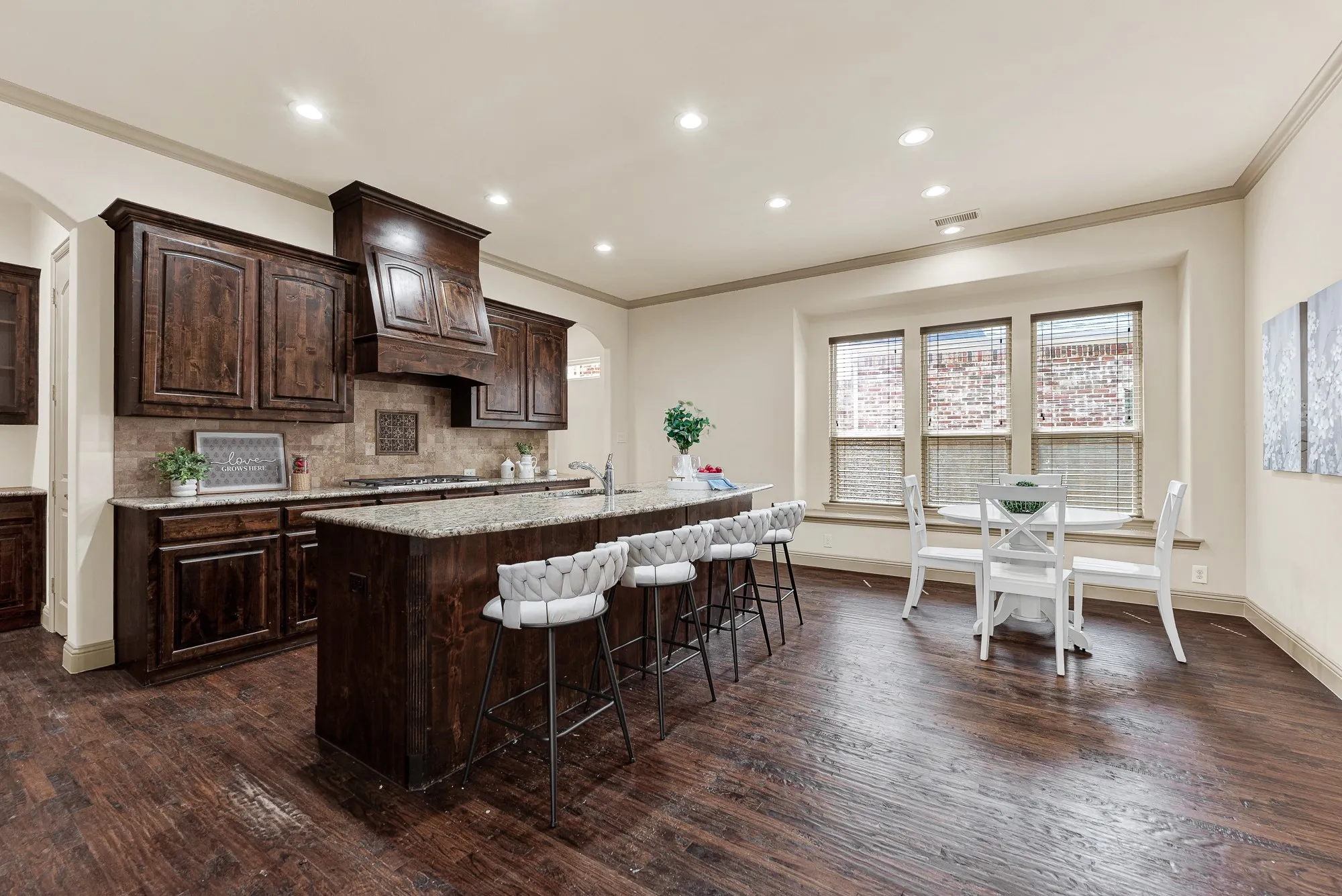 The wide central passageway creates seamless circulation, uniting the specialized serving area with the casual dining space. It makes entertaining effortlessly fluid, whether replenishing party platters from the pantry or chatting with family across the room.