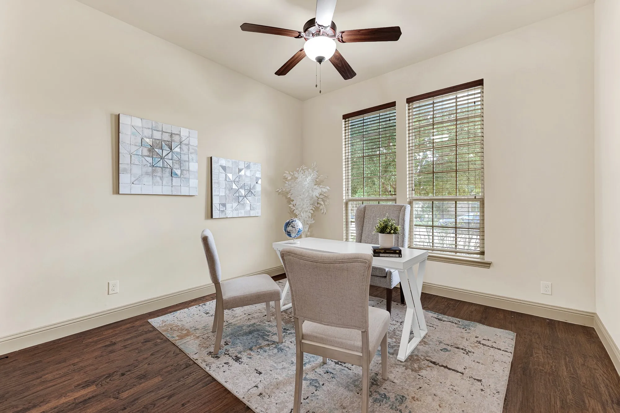 Side-by-side front windows wash the corner in balanced daylight, complemented by high-volume walls and rich plank flooring adorning the first floor guest room. Imagine setting up a dedicated remote workspace or welcoming overnight guests to a quiet, sunlit sanctuary.