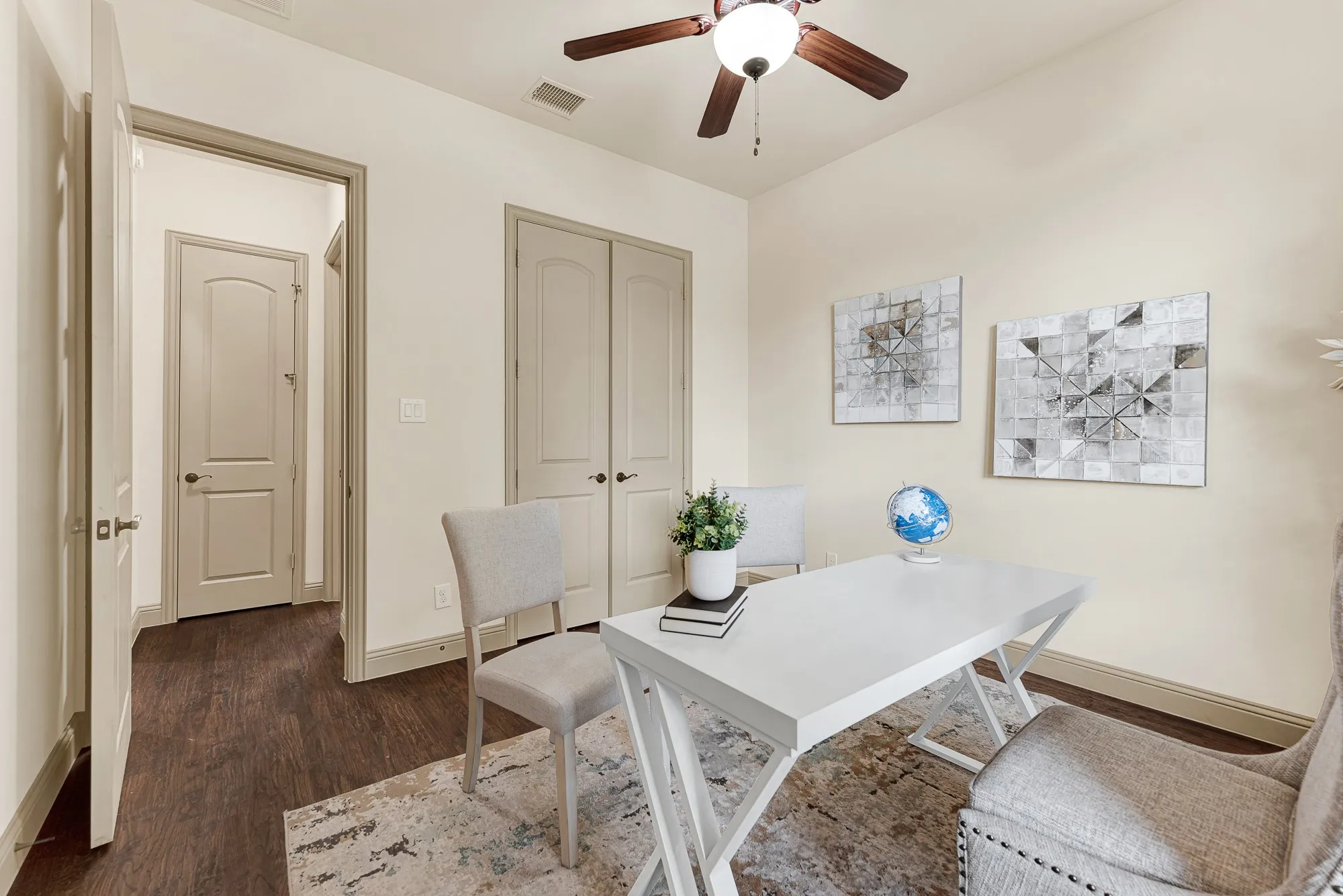 Molded double closet doors and an entrance to the first floor guest room create clean architectural balance along the interior wall. It ensures visiting family members enjoy effortless privacy and dedicated storage throughout a relaxing weekend stay.