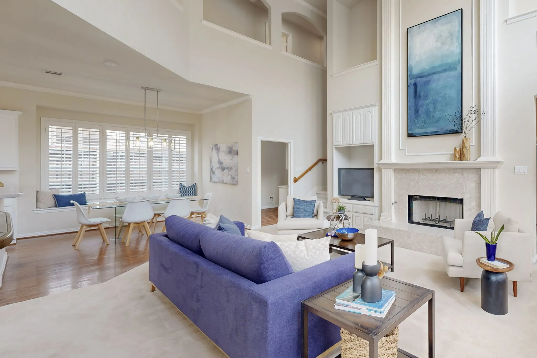 Soaring ceilings, expansive windows, and a stunning fireplace create a bright and inviting living space