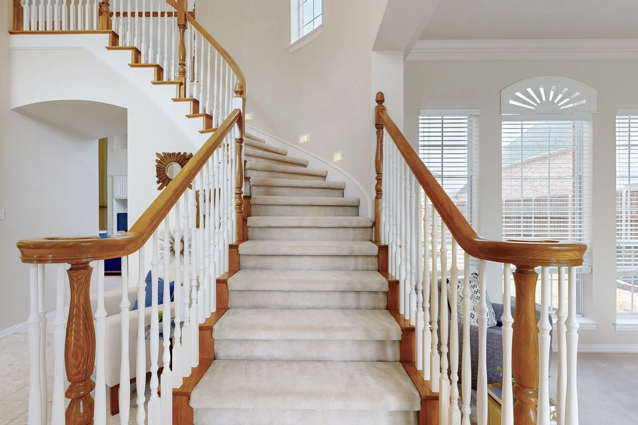 Elegant curved staircase and soaring entryway set the tone for this beautifully designed home