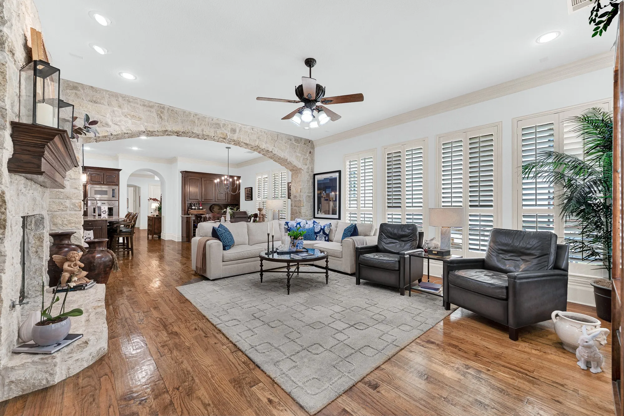 The grand masonry passage creates a warm boundary while keeping sightlines open to the heart of the home. Settle in for effortless conversations with guests as prep work continues nearby.