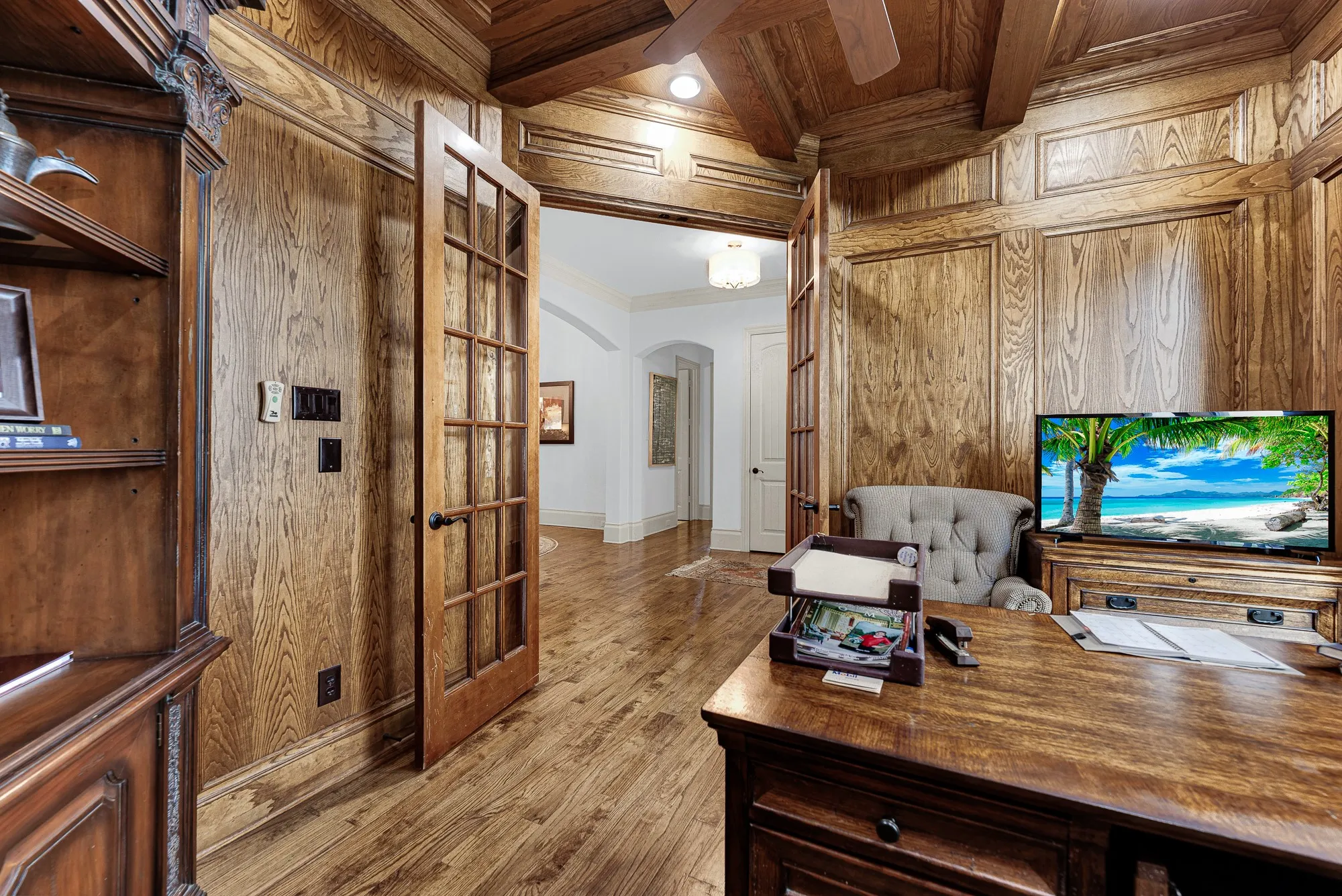 Divided-lite glass double doors offer privacy while maintaining an open visual connection to the main living areas. Close the entry during important calls, creating a quiet sanctuary for uninterrupted concentration throughout the day.