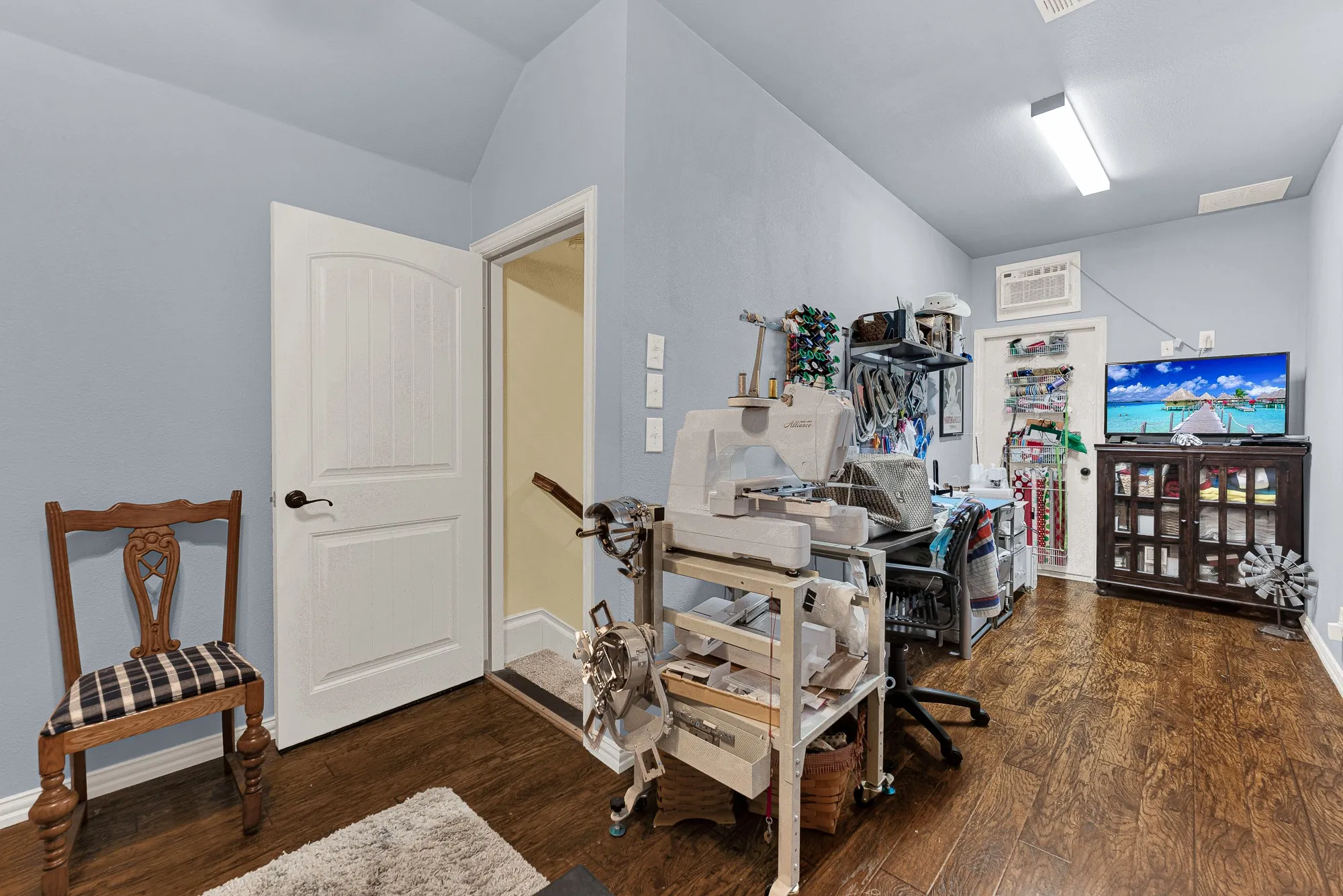 Angled ceilings lead up from the private stairwell into a bright second-floor flex space grounded by warm wooden flooring. Set up a dedicated hobby studio where creativity flows uninterrupted all afternoon.