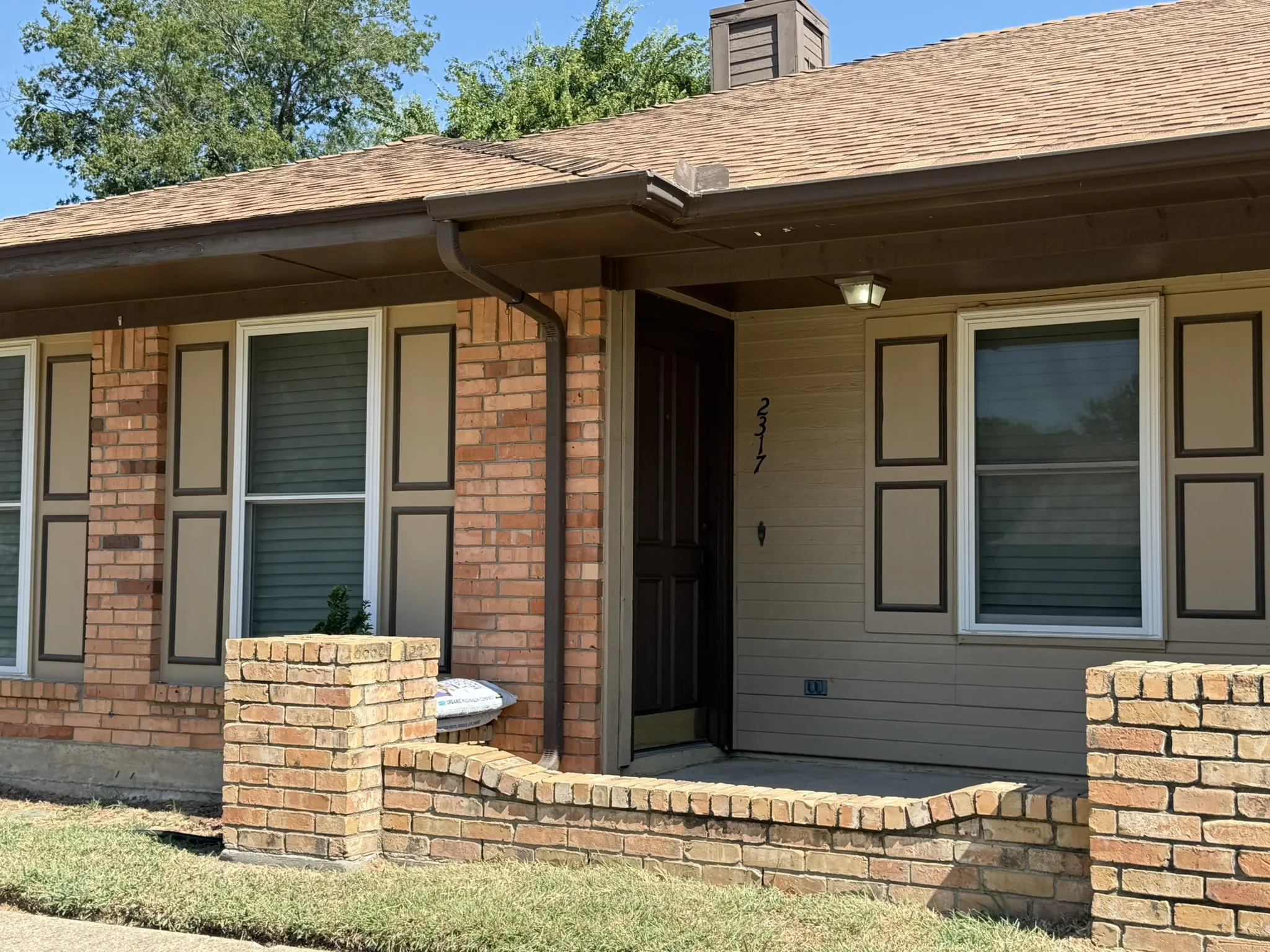 Brick and siding exterior with a shingle roof